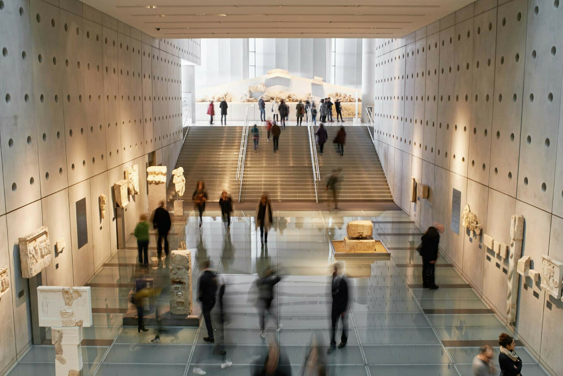 a group of people walking down a hall way