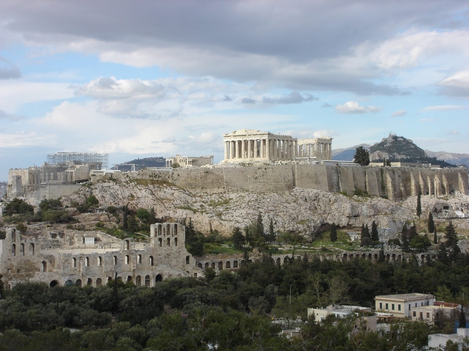 a large stone building on a hill