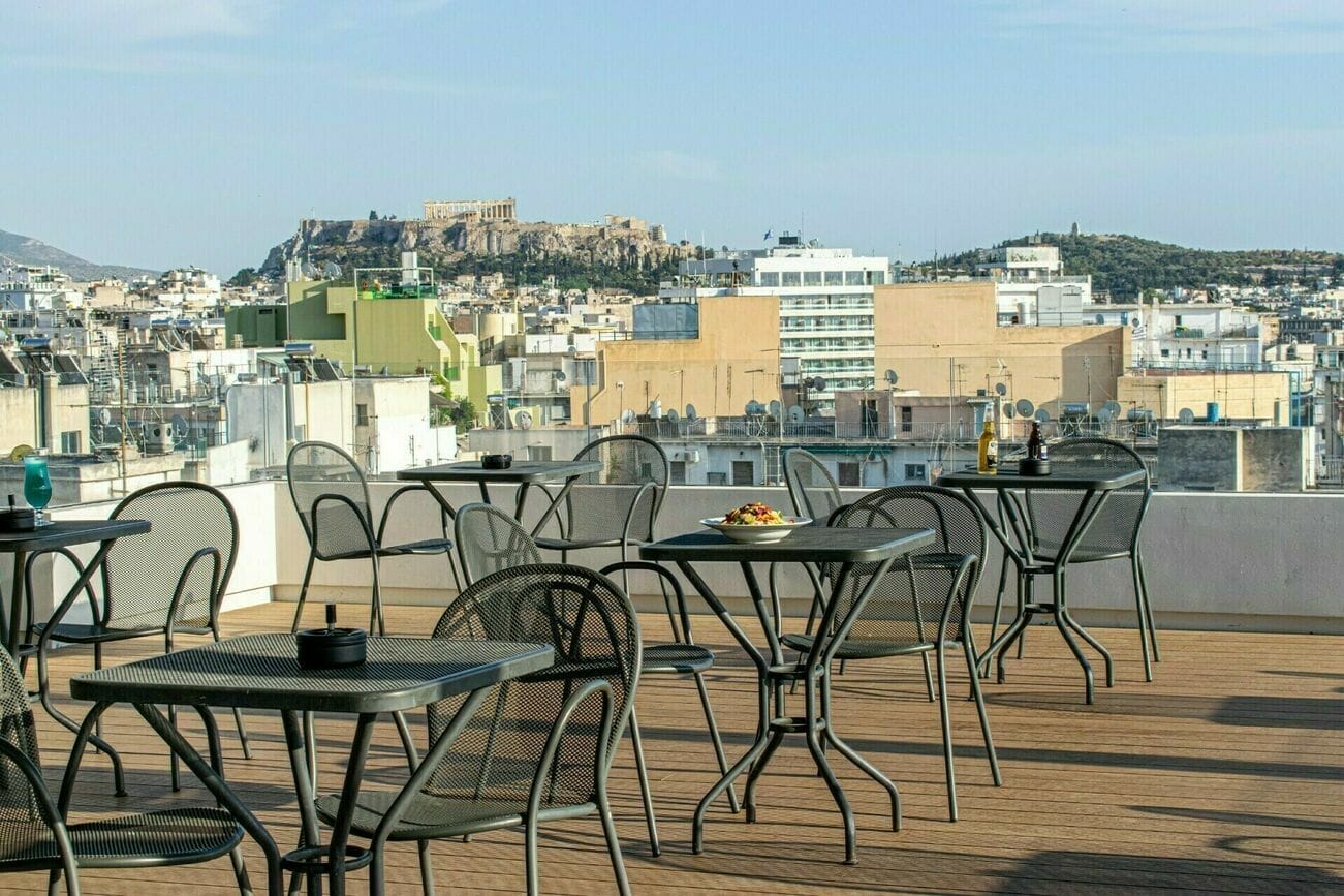 a group of tables and chairs on a rooftop