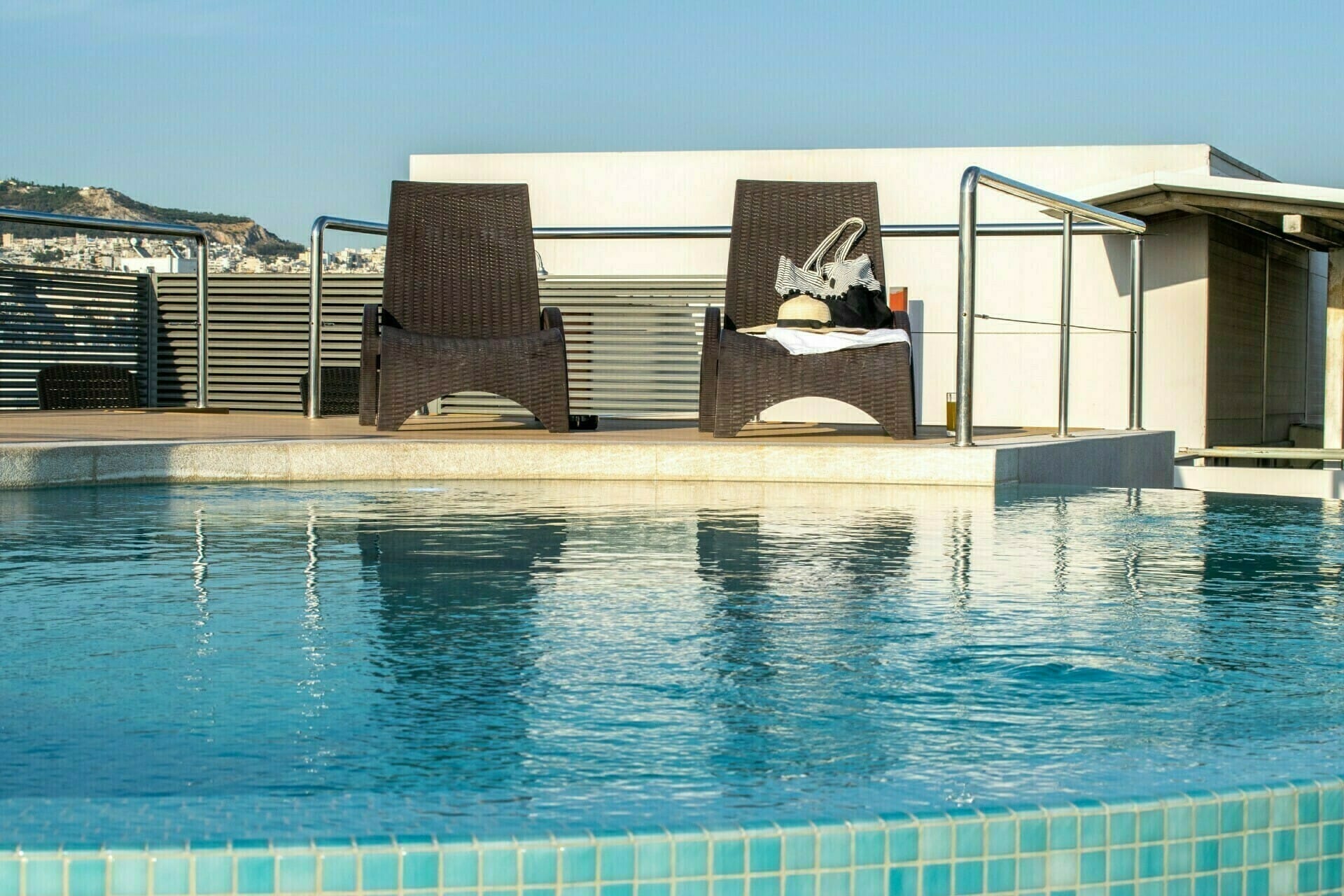 a swimming pool with a house in the background