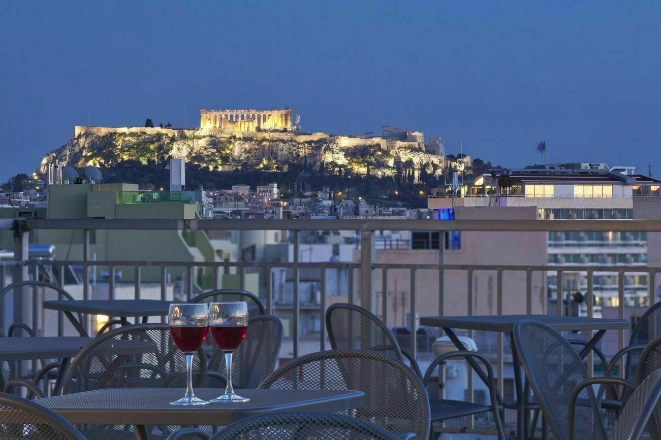 a couple of glasses of wine on a table in front of a building