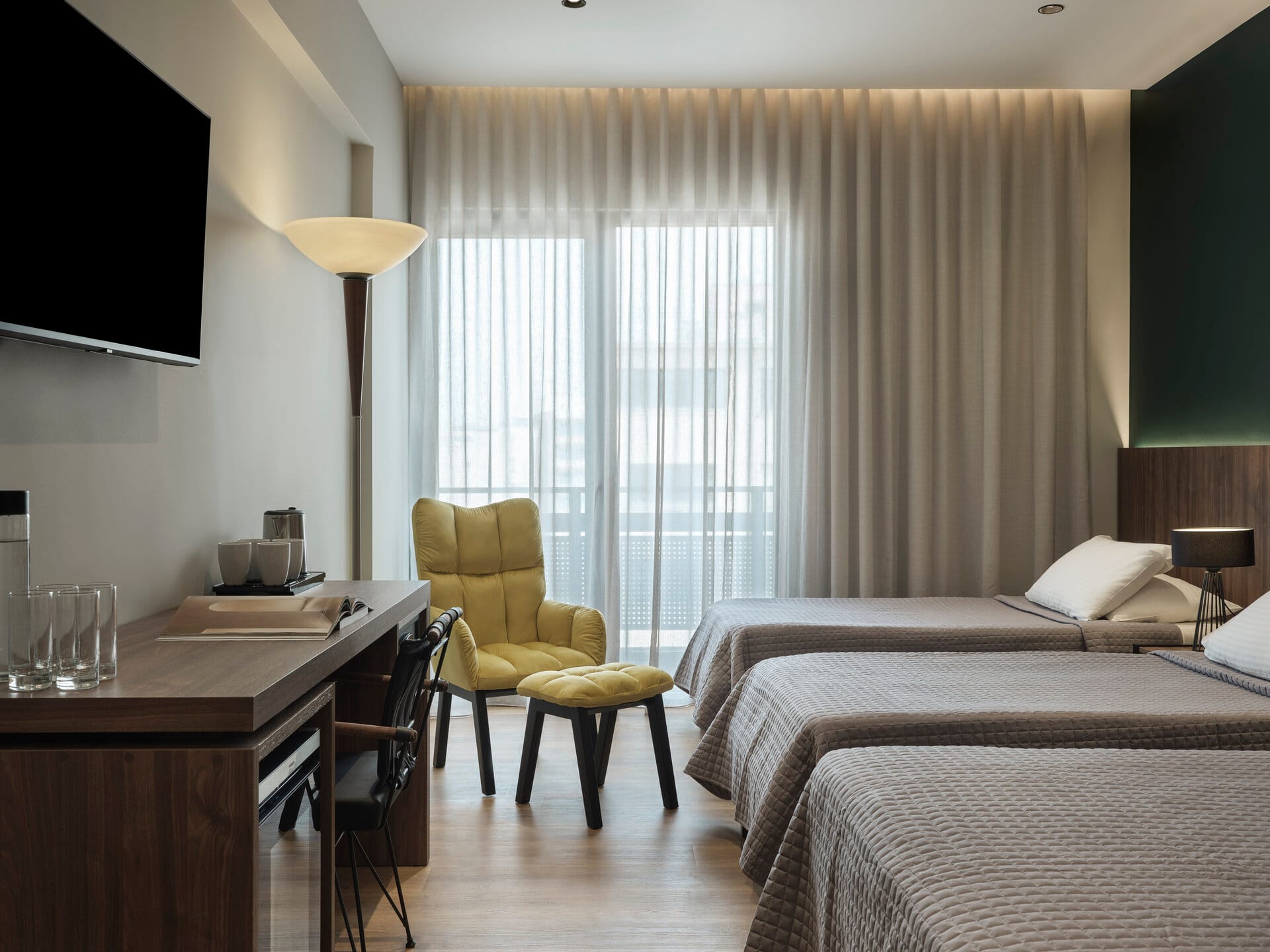 a hotel room with a bed and desk