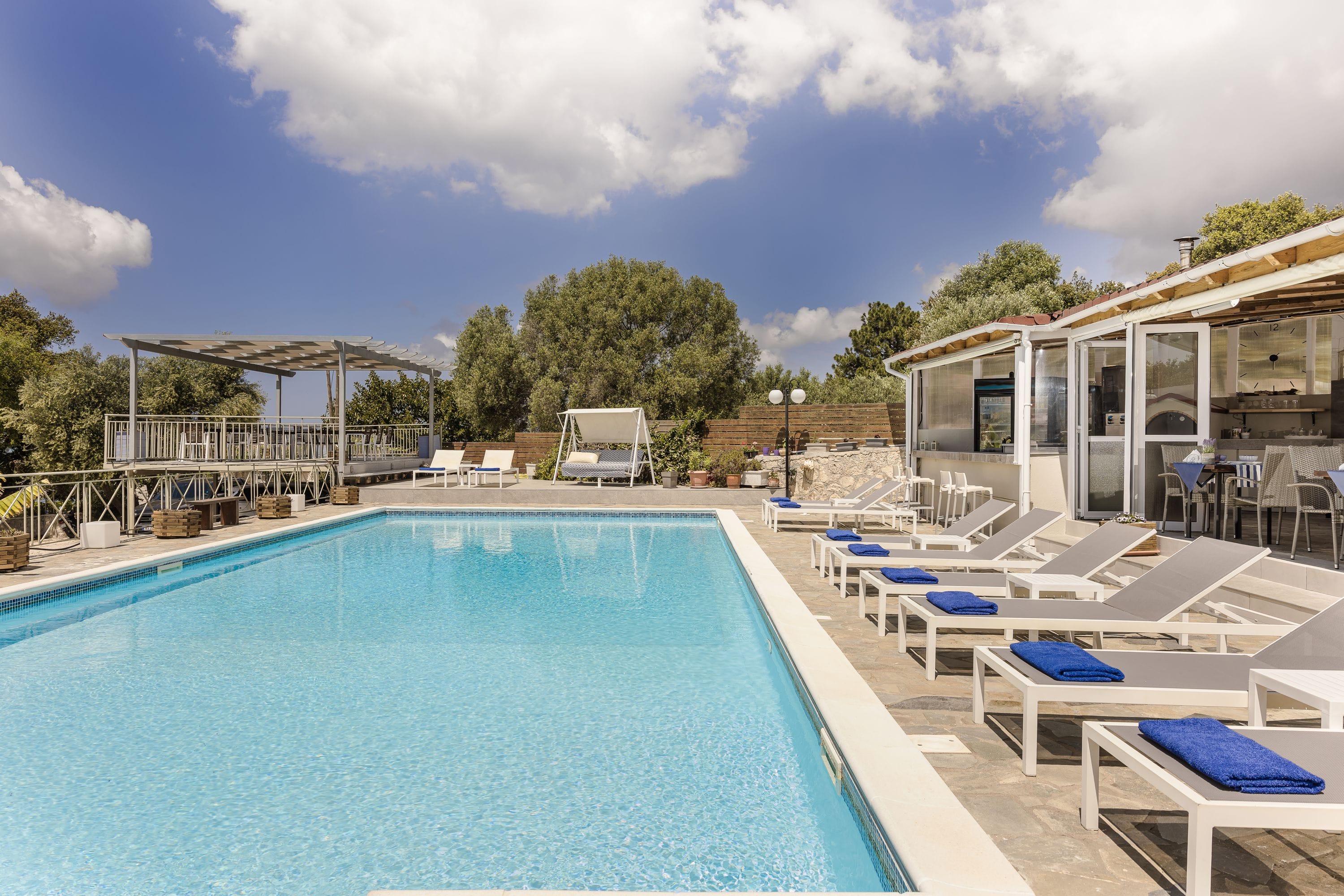 a swimming pool with lounge chairs