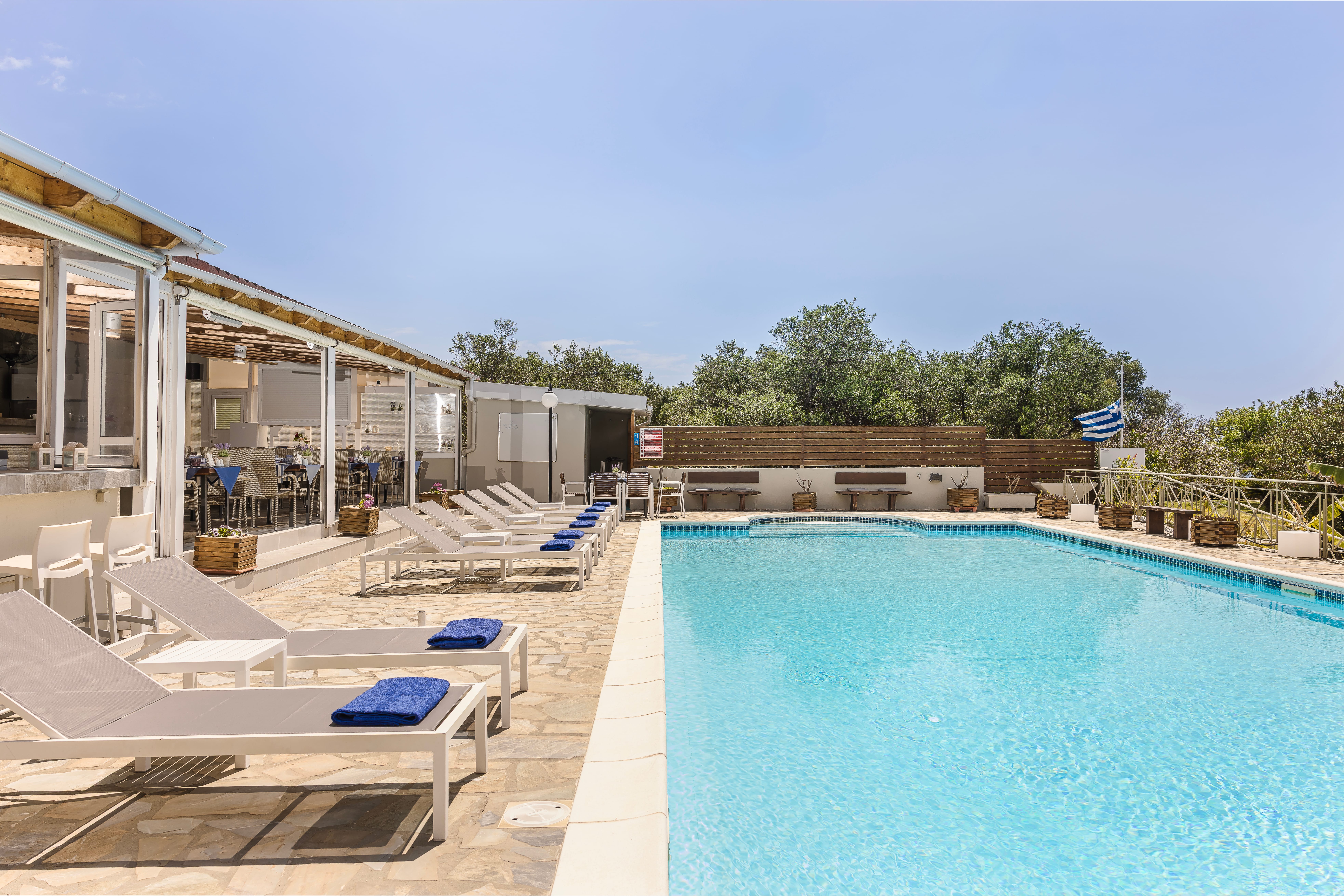 a swimming pool with chairs around it