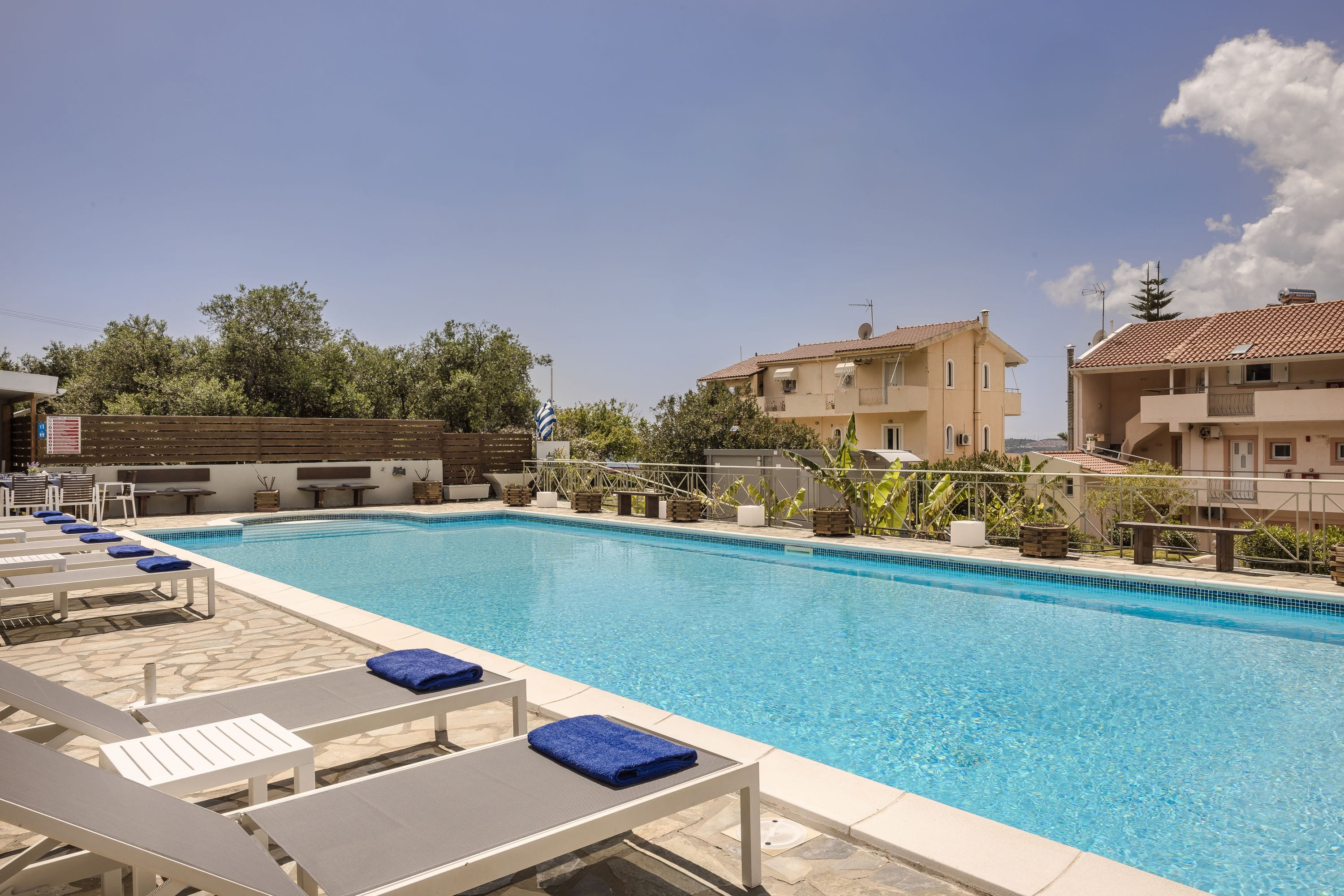 a swimming pool with lounge chairs