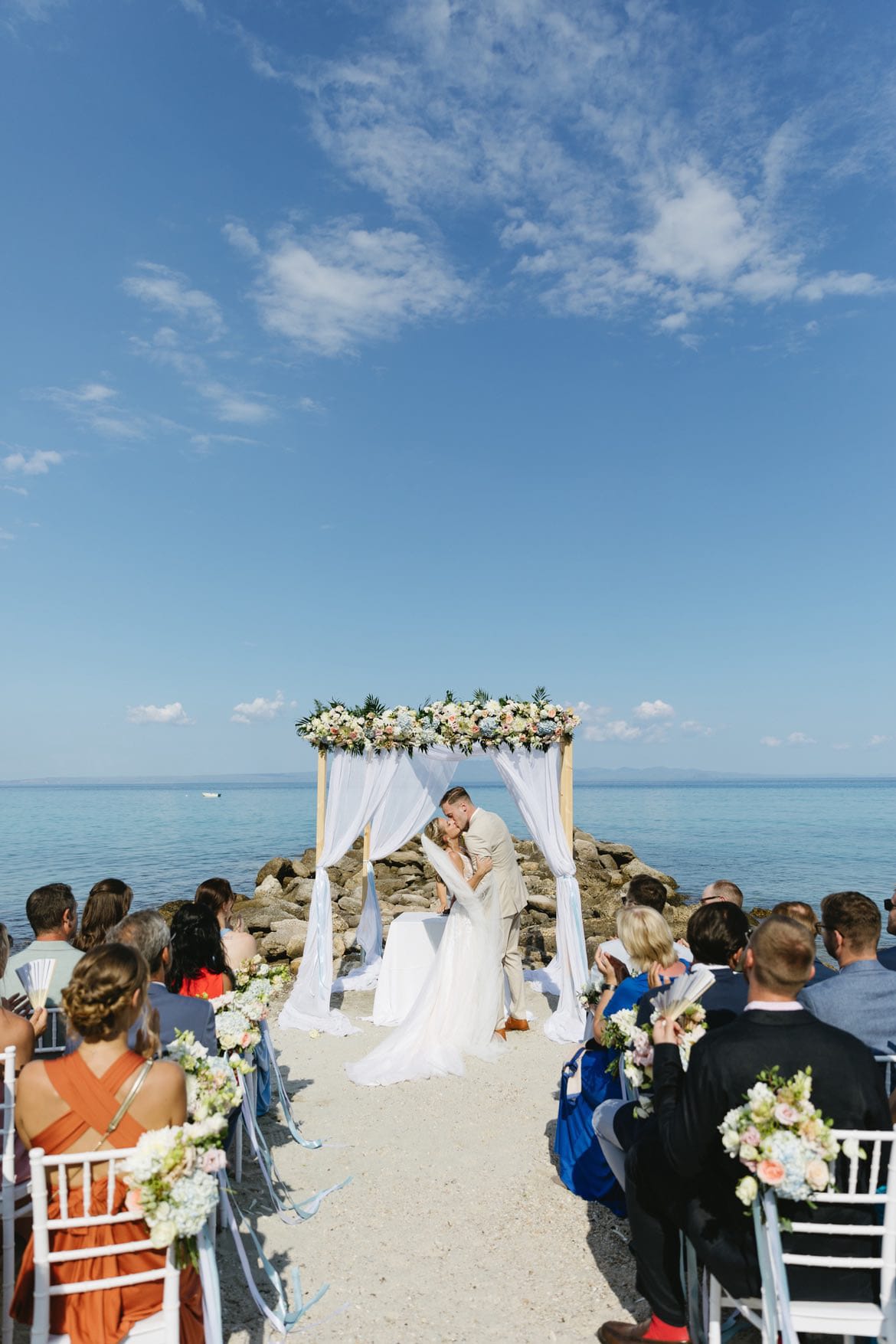 a bride and groom walking down the aisle