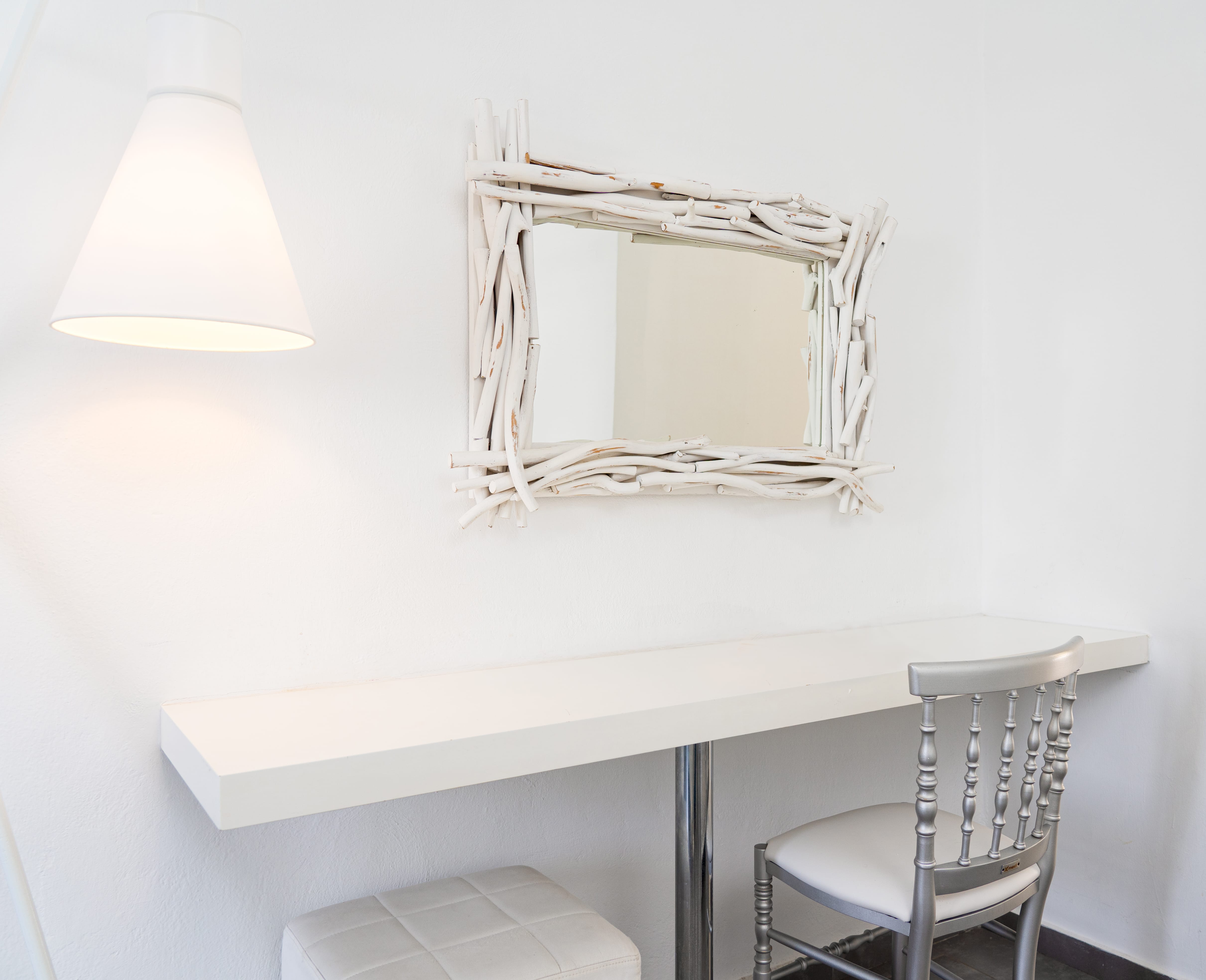 a white table with a chair and a lamp