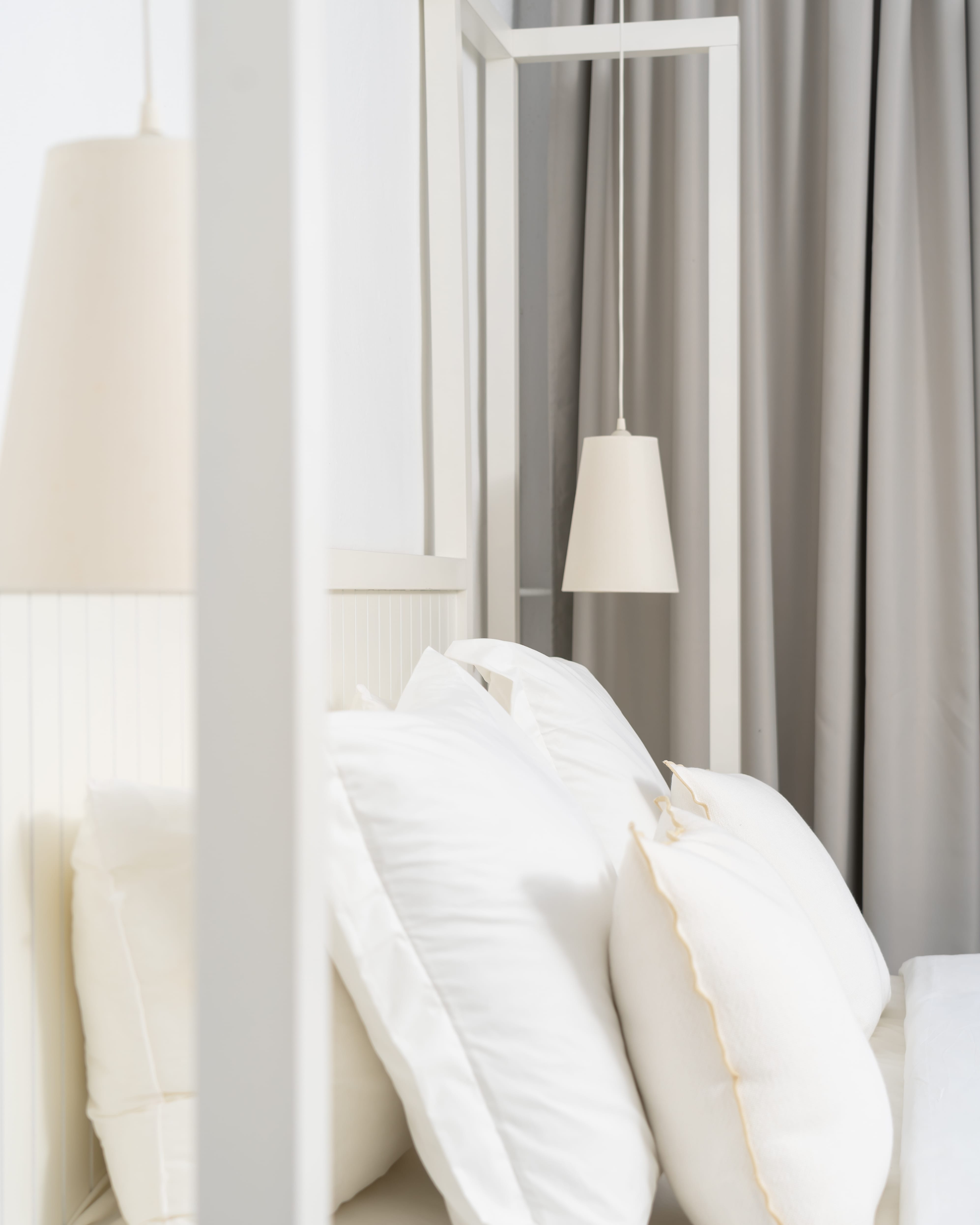a white bed with white sheets