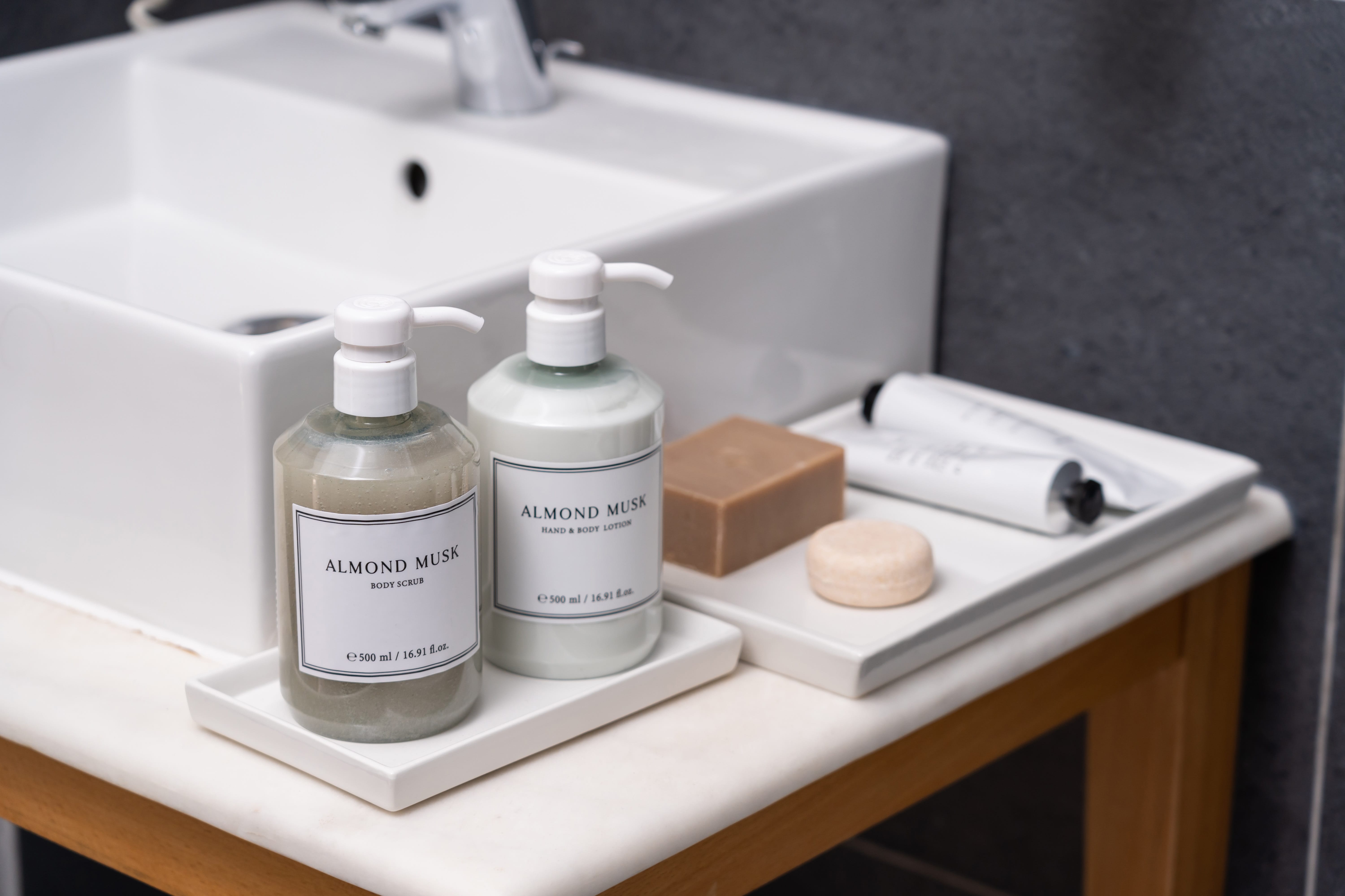 a white sink with bottles of soap