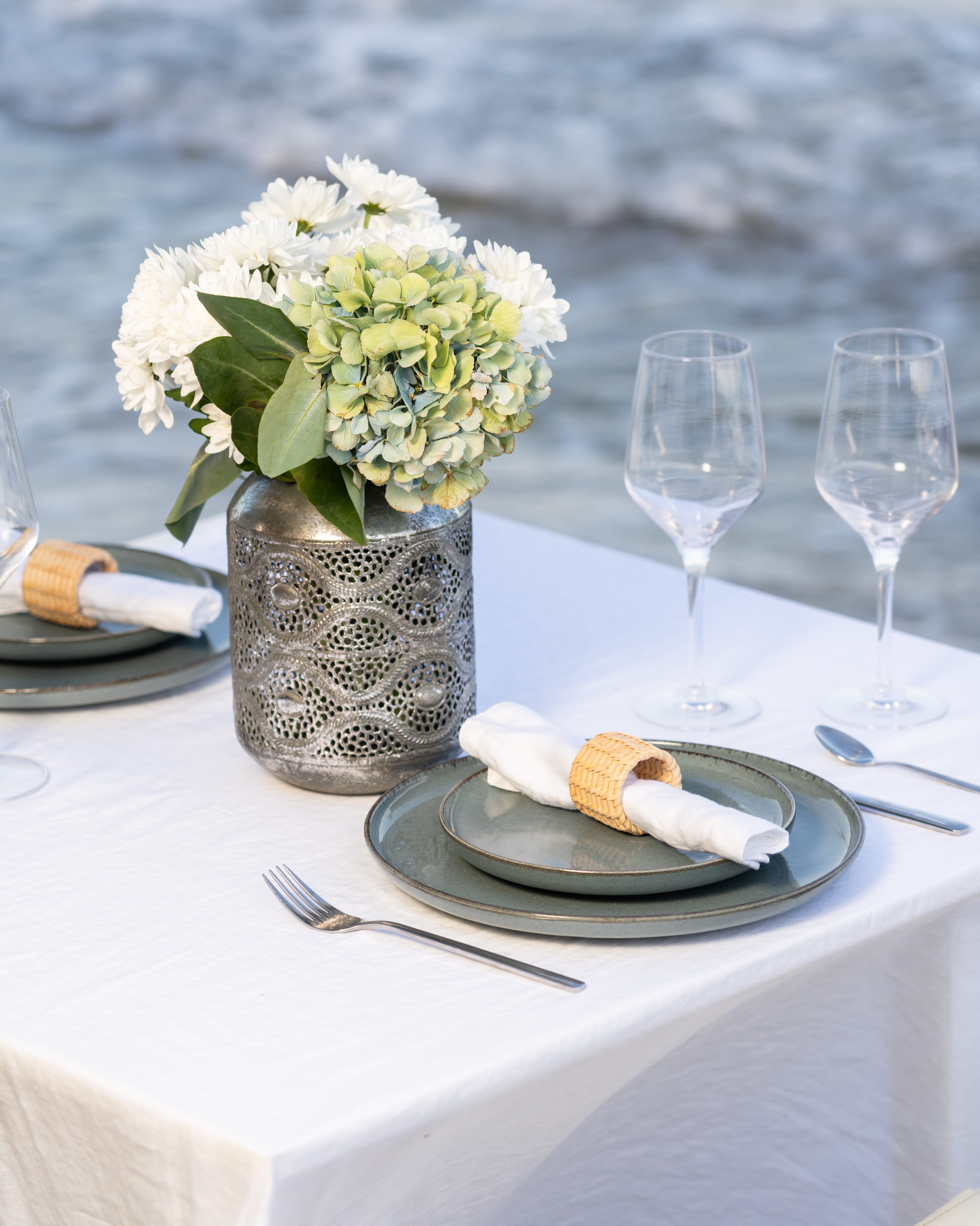 a vase with white flowers on a table