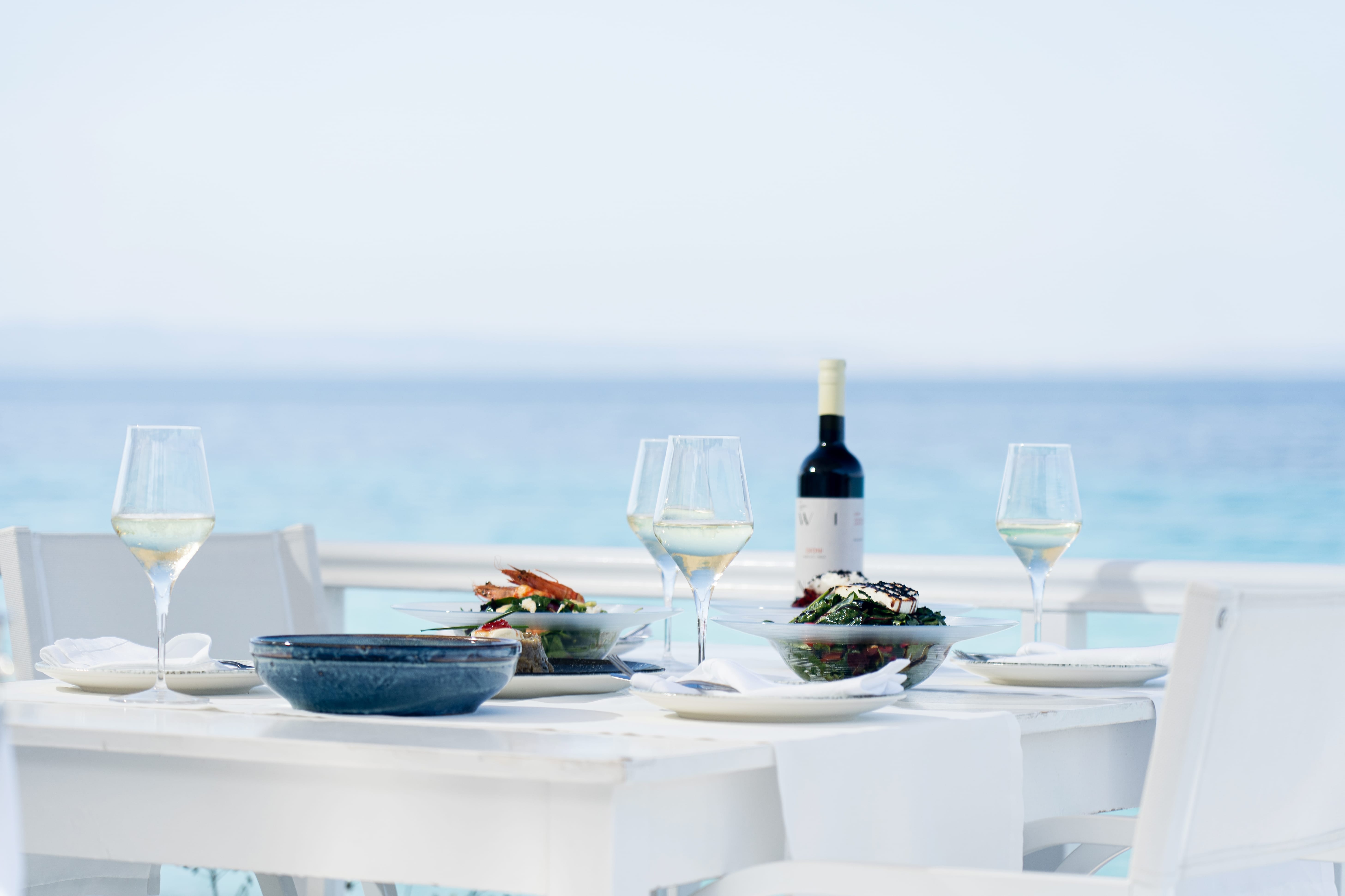 a table with wine glasses and plates