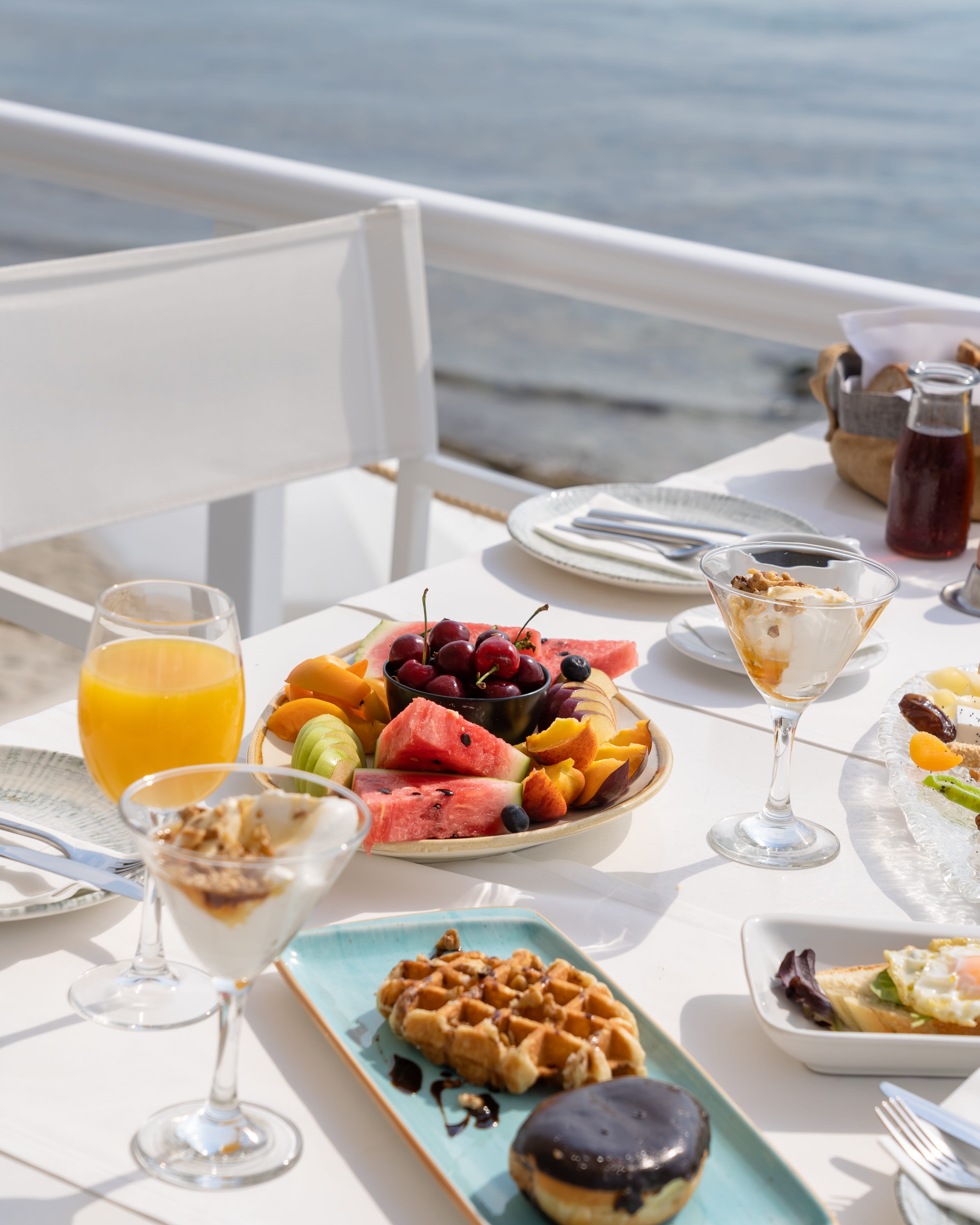 a table with plates of food and glasses of wine