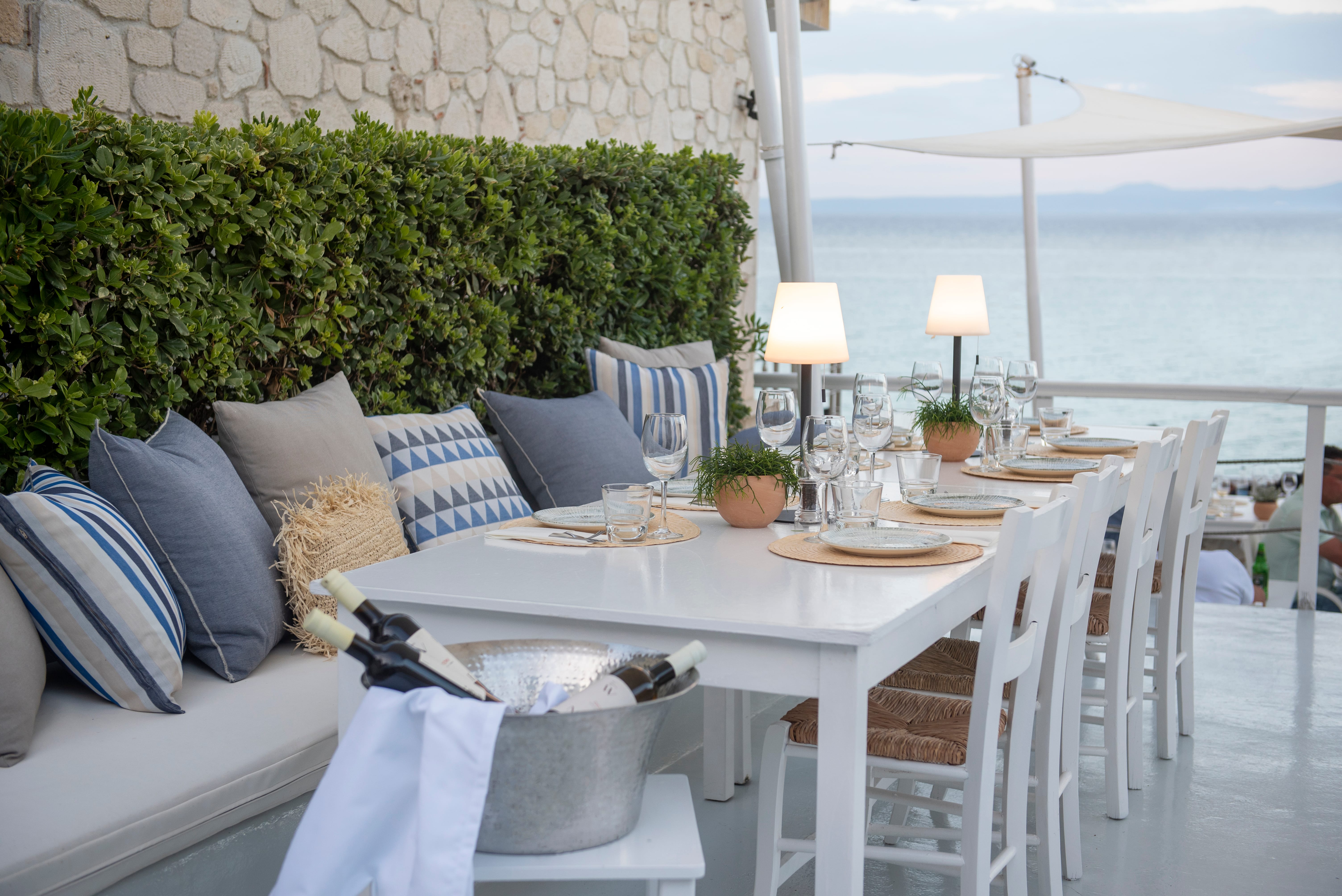 a table with white chairs and a white table with a white table and a white table with a