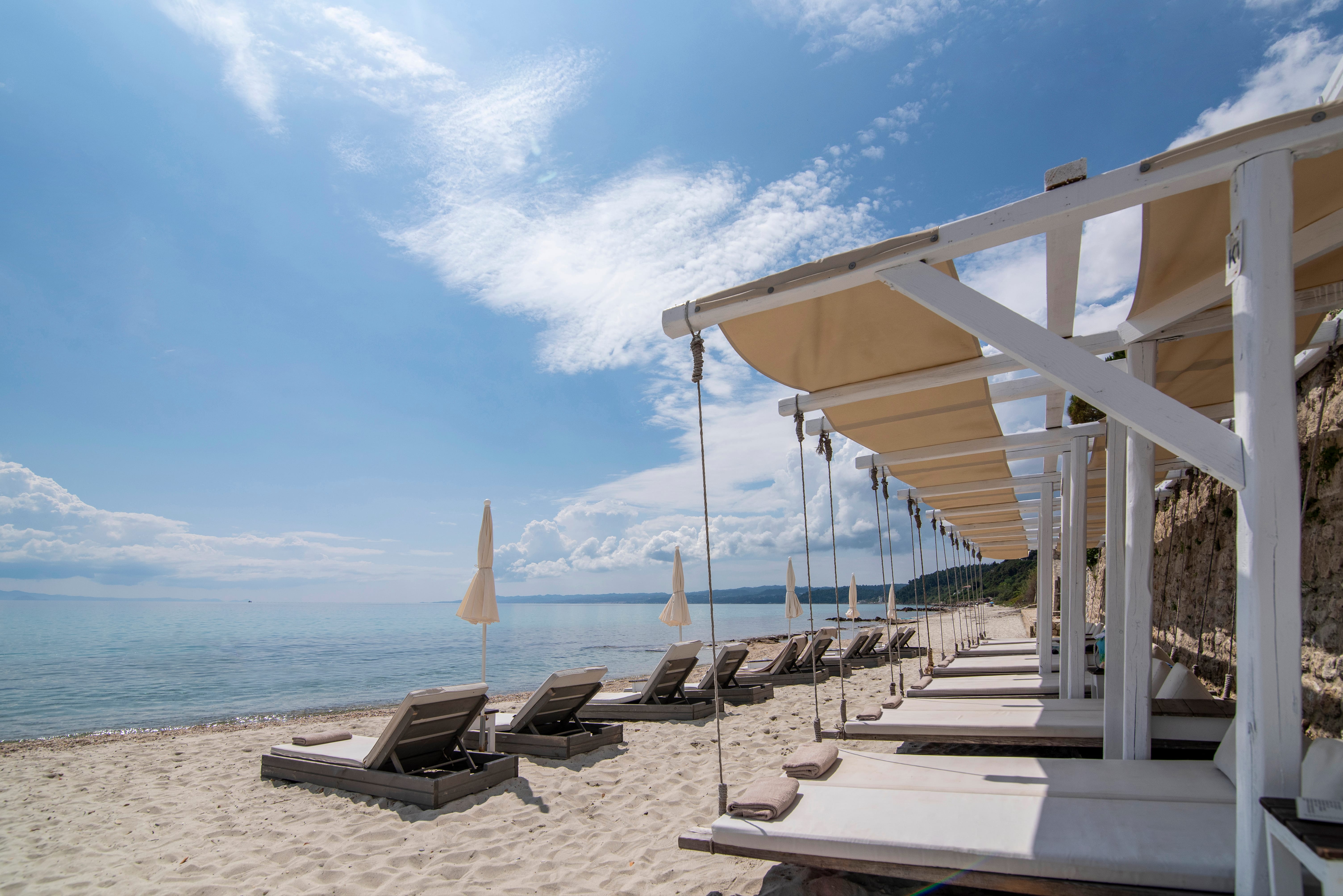 a beach with a deck and chairs