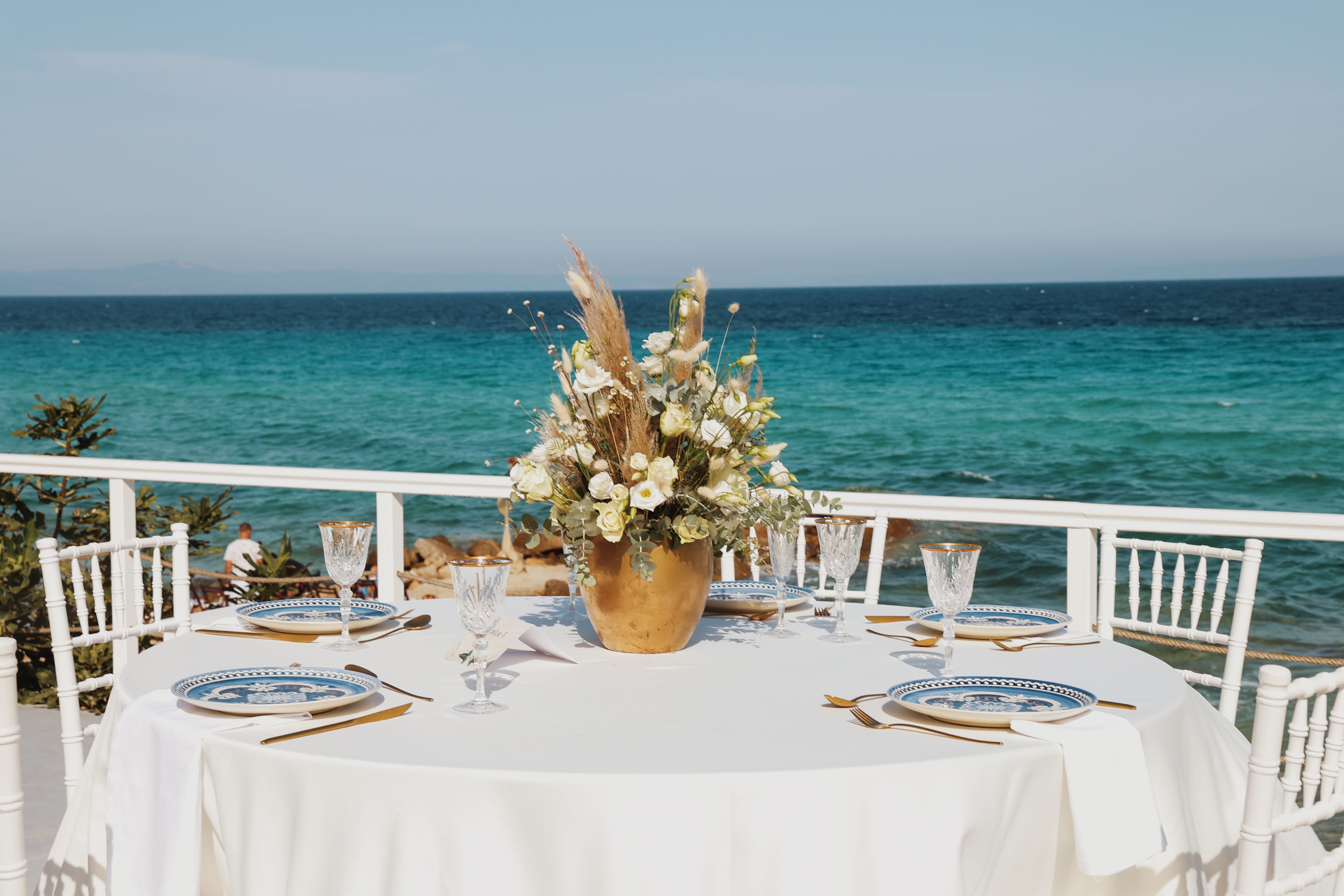 a table with a plant on it by a body of water