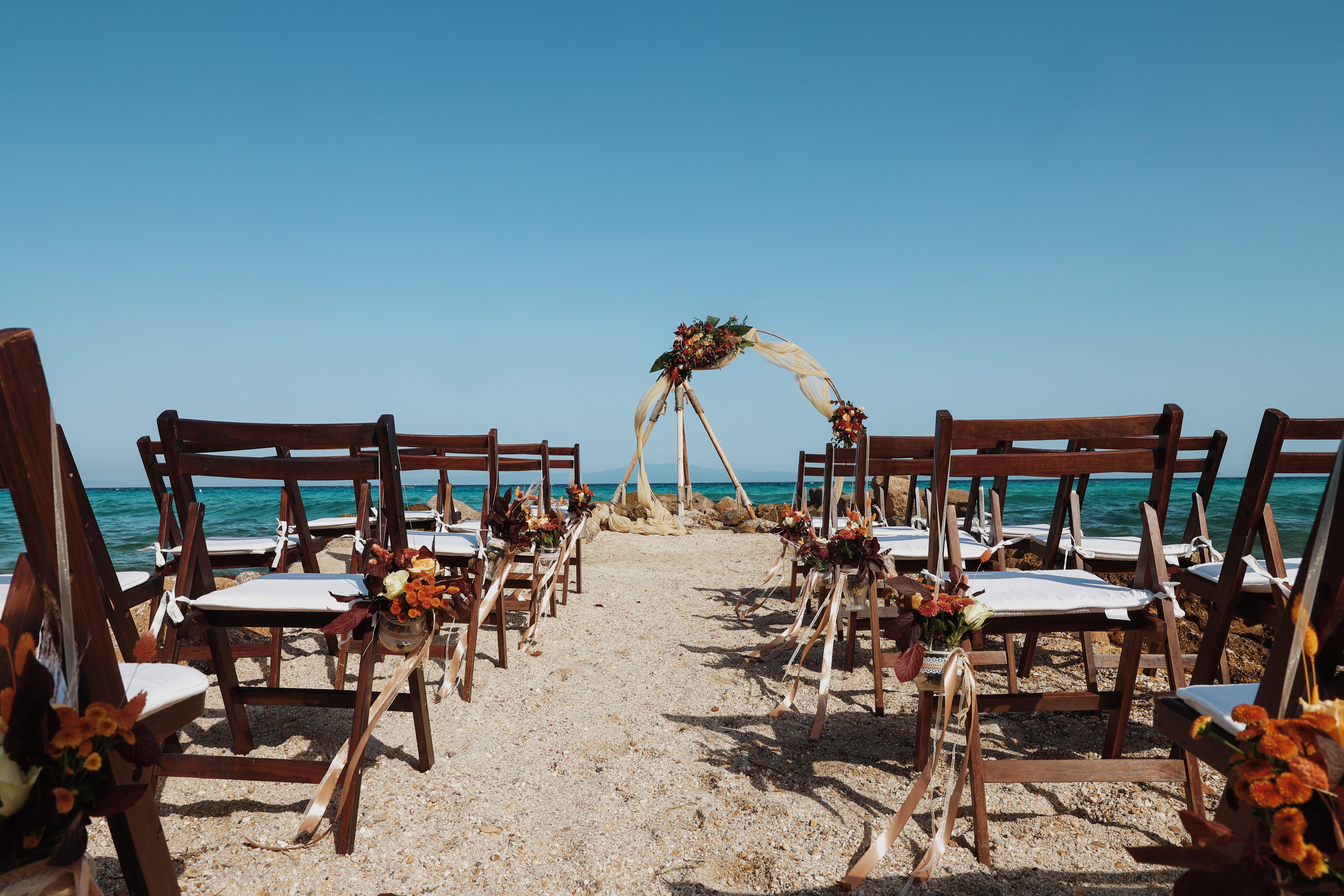 a beach with tables and chairs