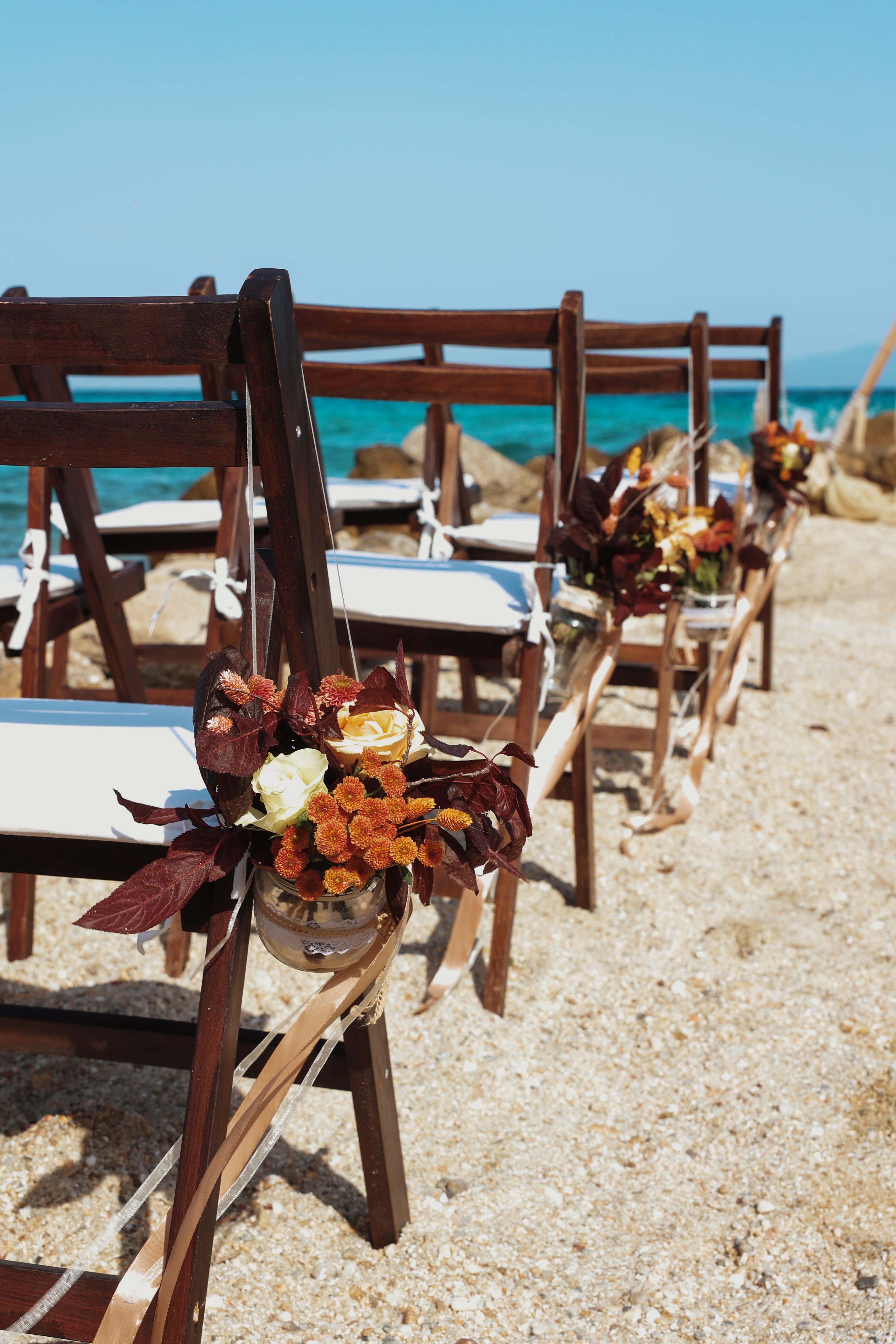 a group of chairs with flowers in front of them