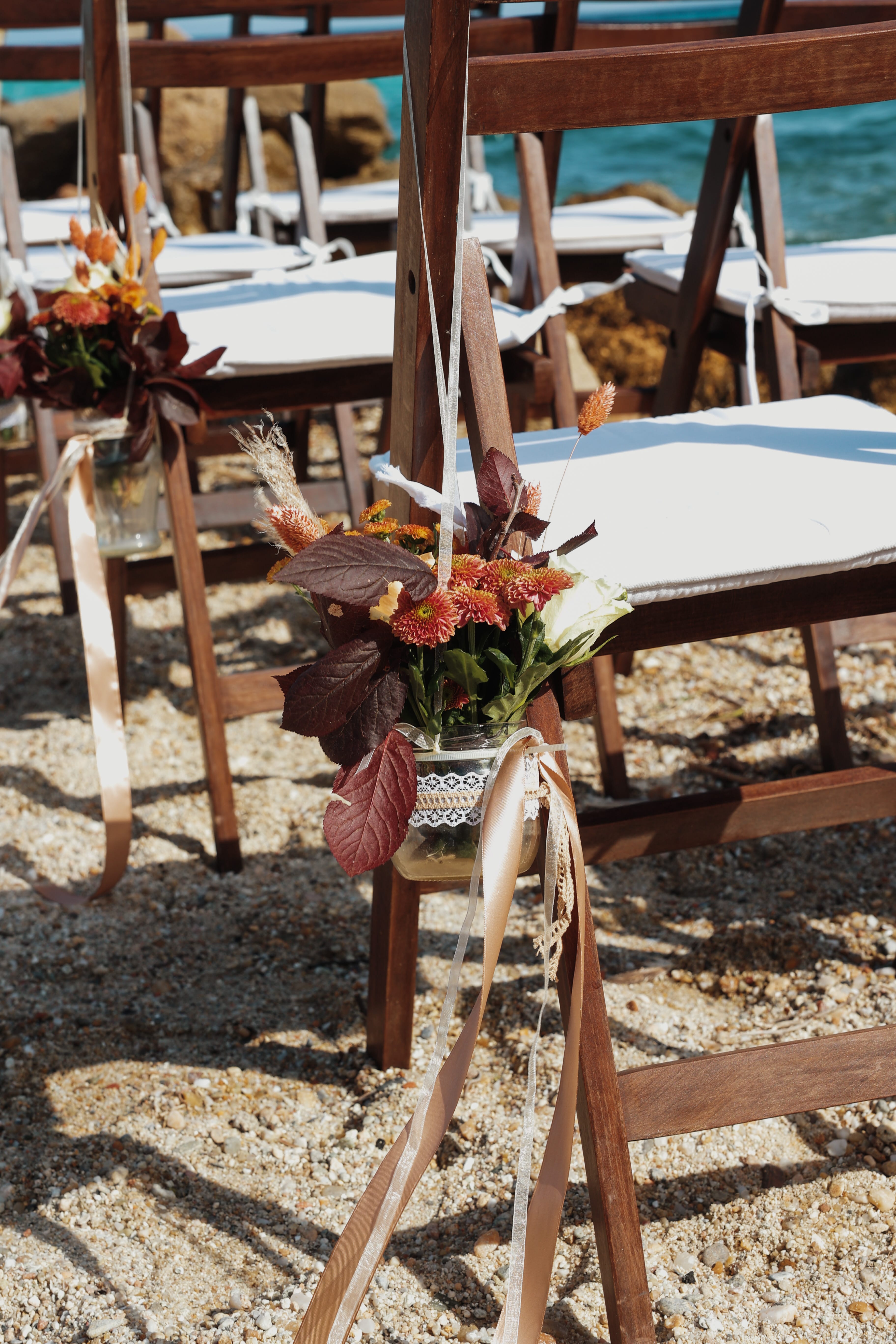 a group of chairs with flowers in them
