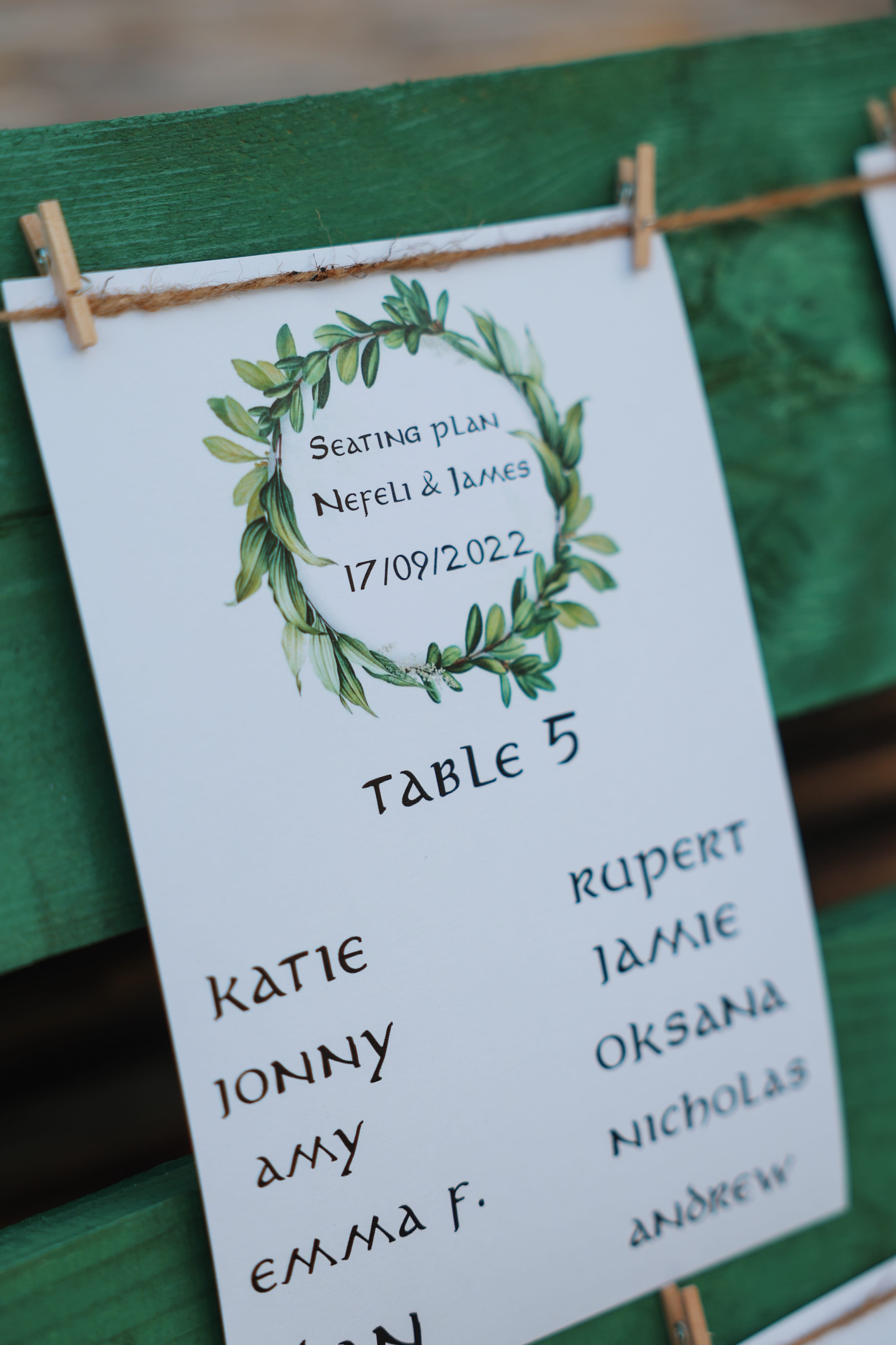 a green and white sign with a tree on it