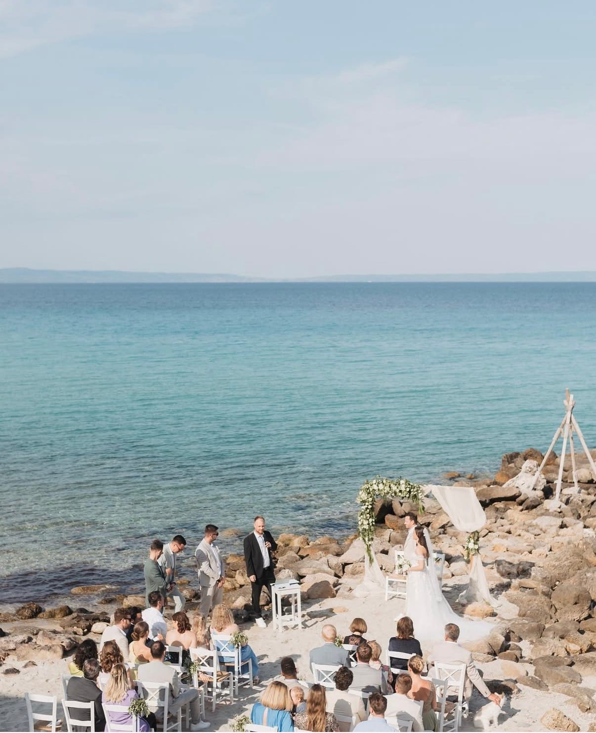 a group of people sitting on a beach