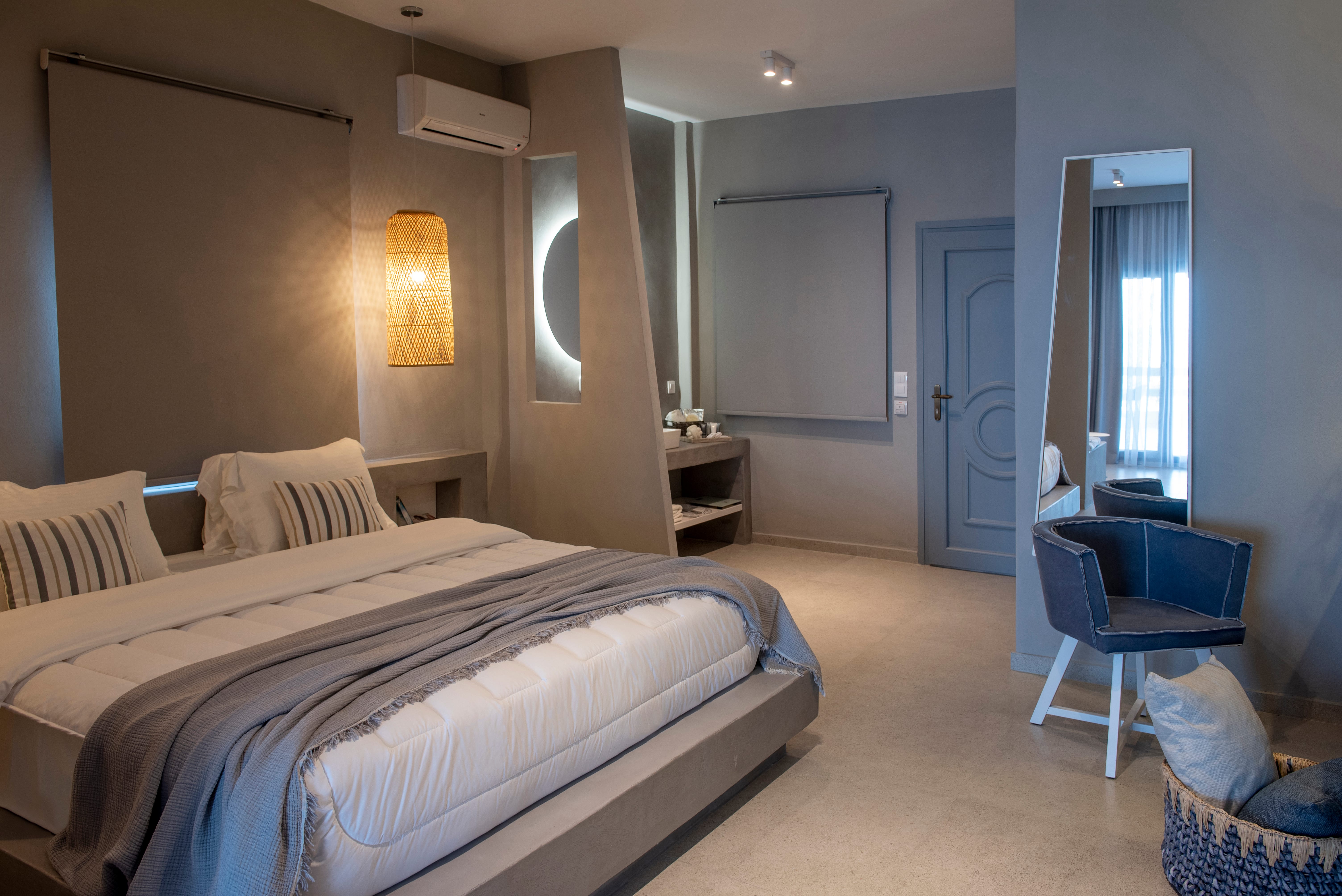 a bedroom with a bed and chairs