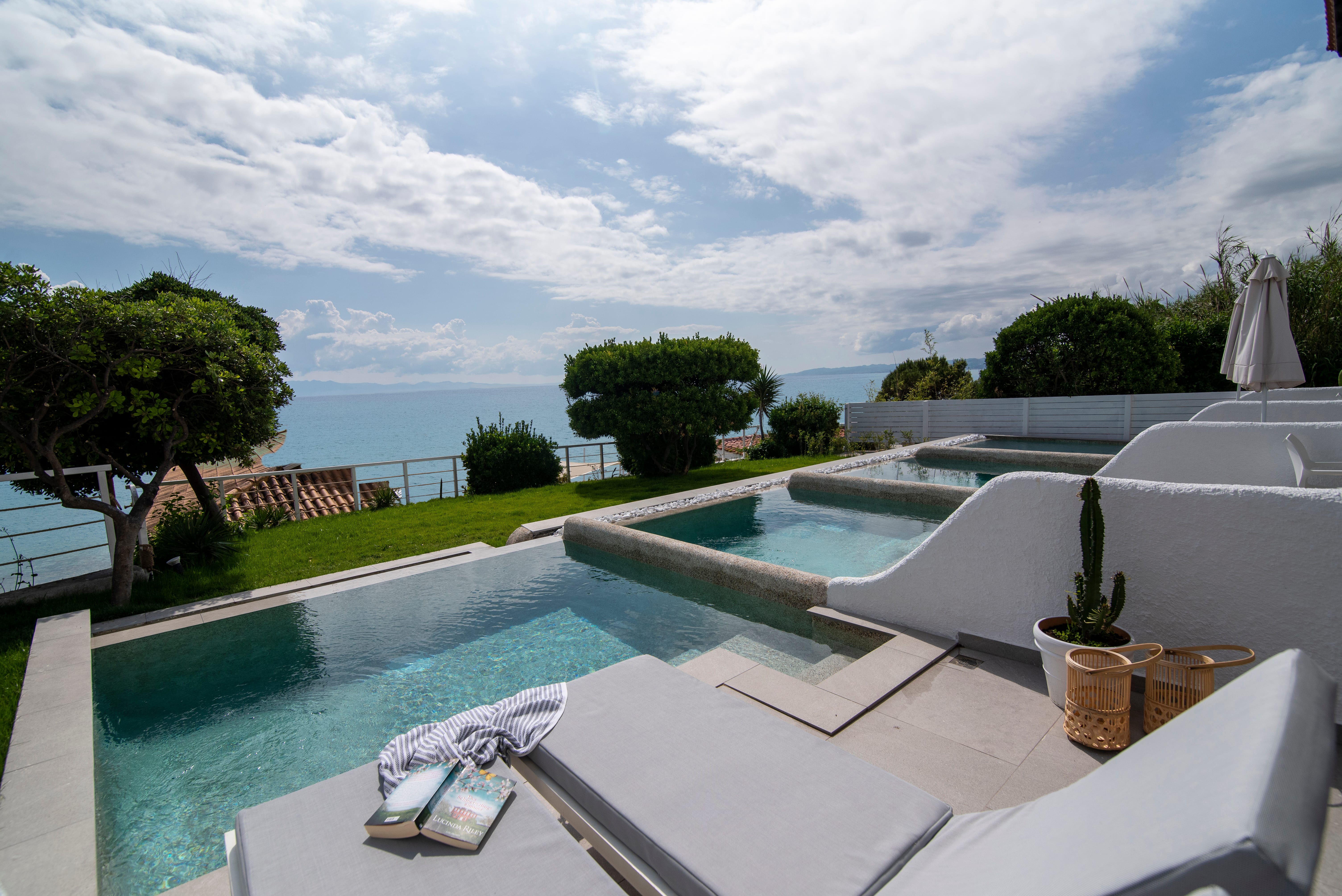 a pool with a deck and chairs