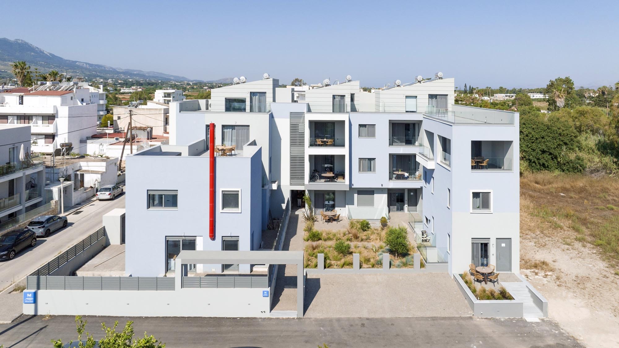 a white building with a red and blue roof