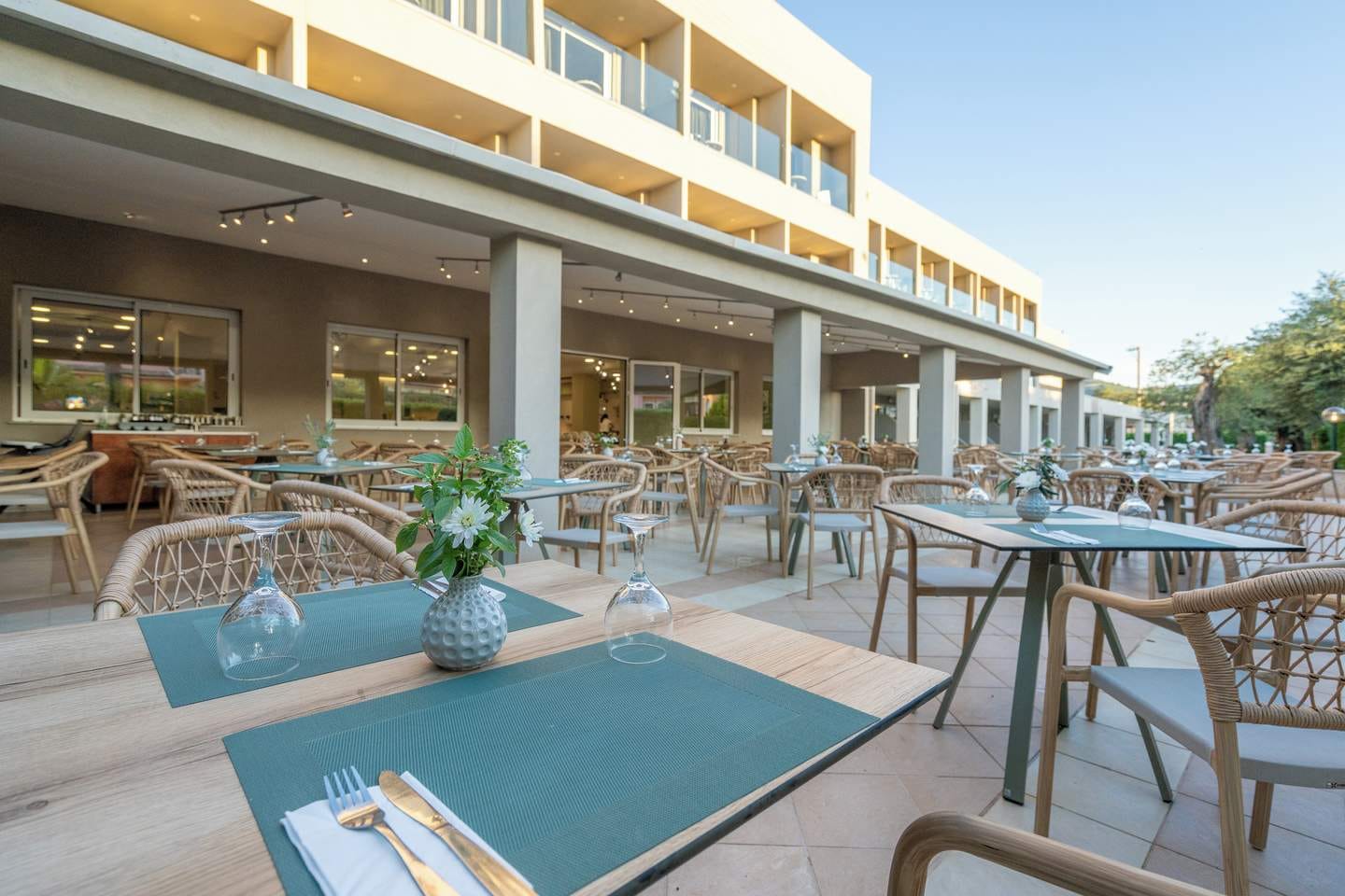 a pool with tables and chairs outside a building