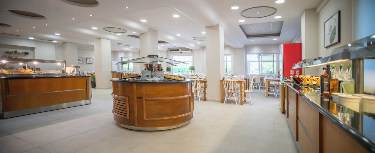 a large room with a bar and chairs