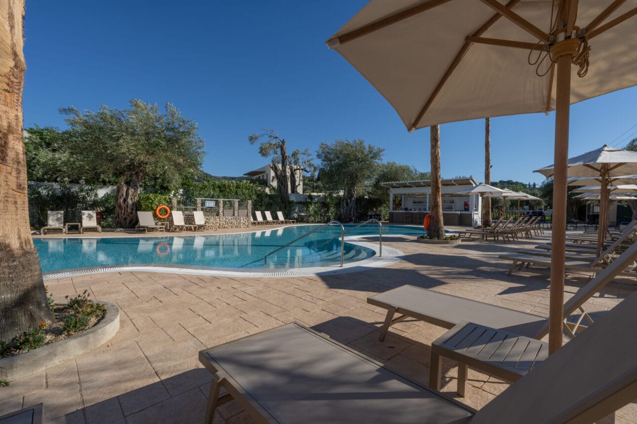a pool with lounge chairs and umbrellas