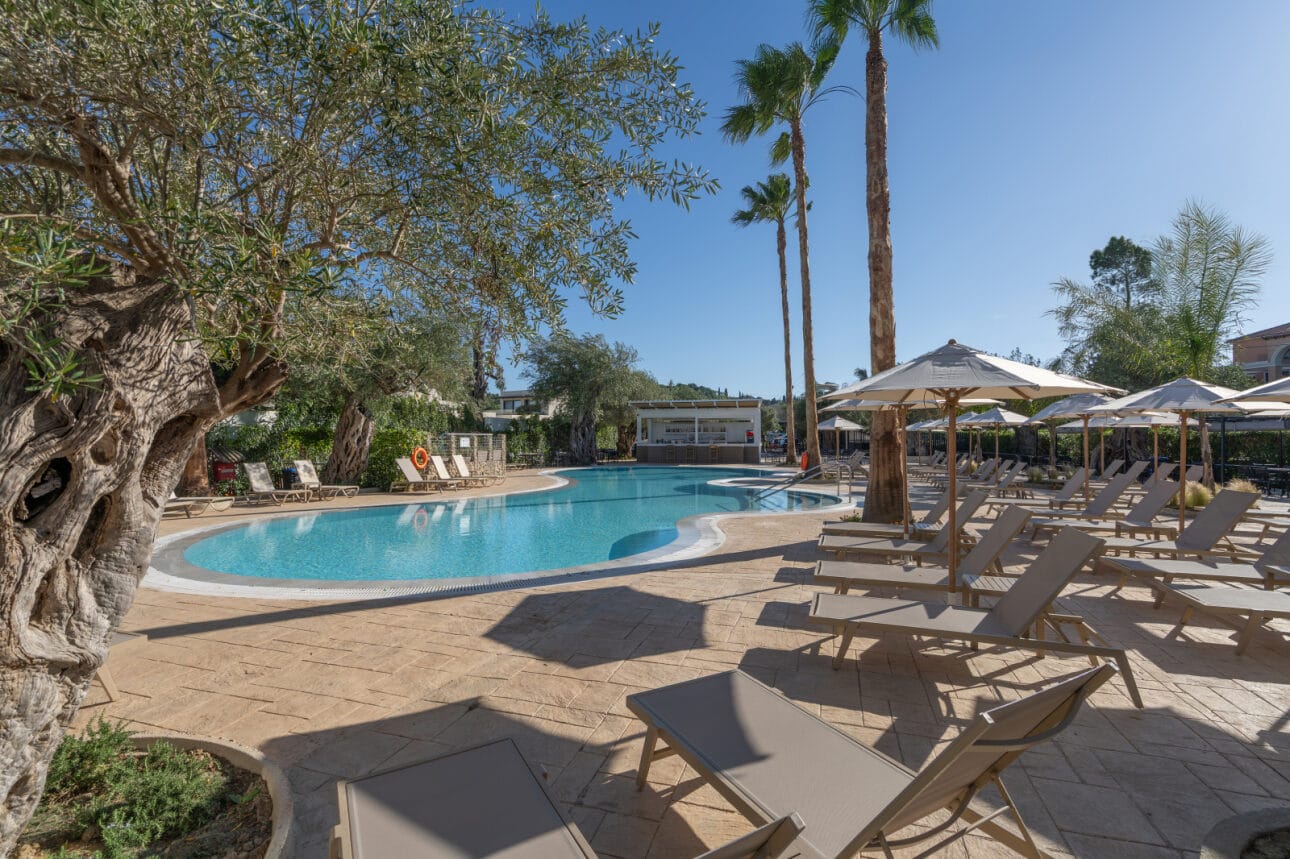 a pool with lounge chairs and umbrellas