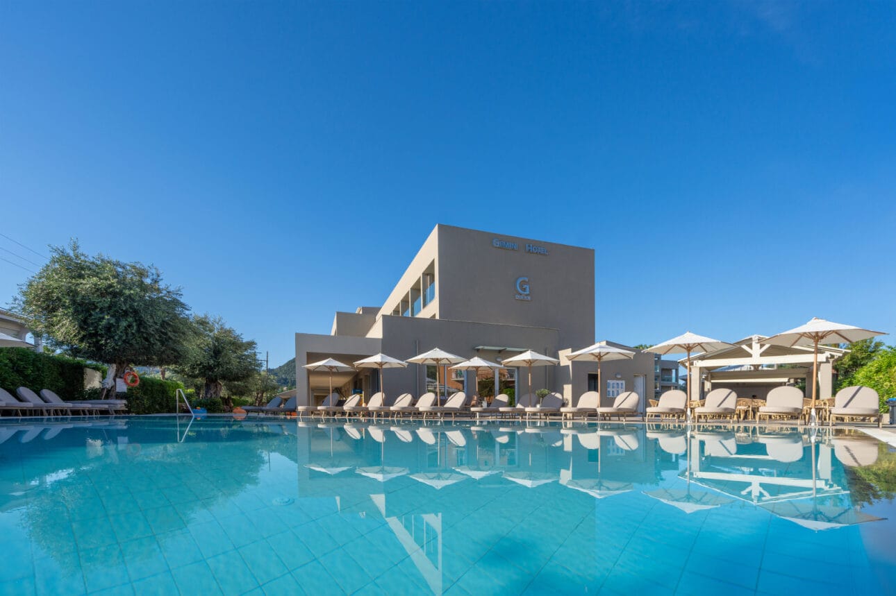 a pool with chairs and umbrellas