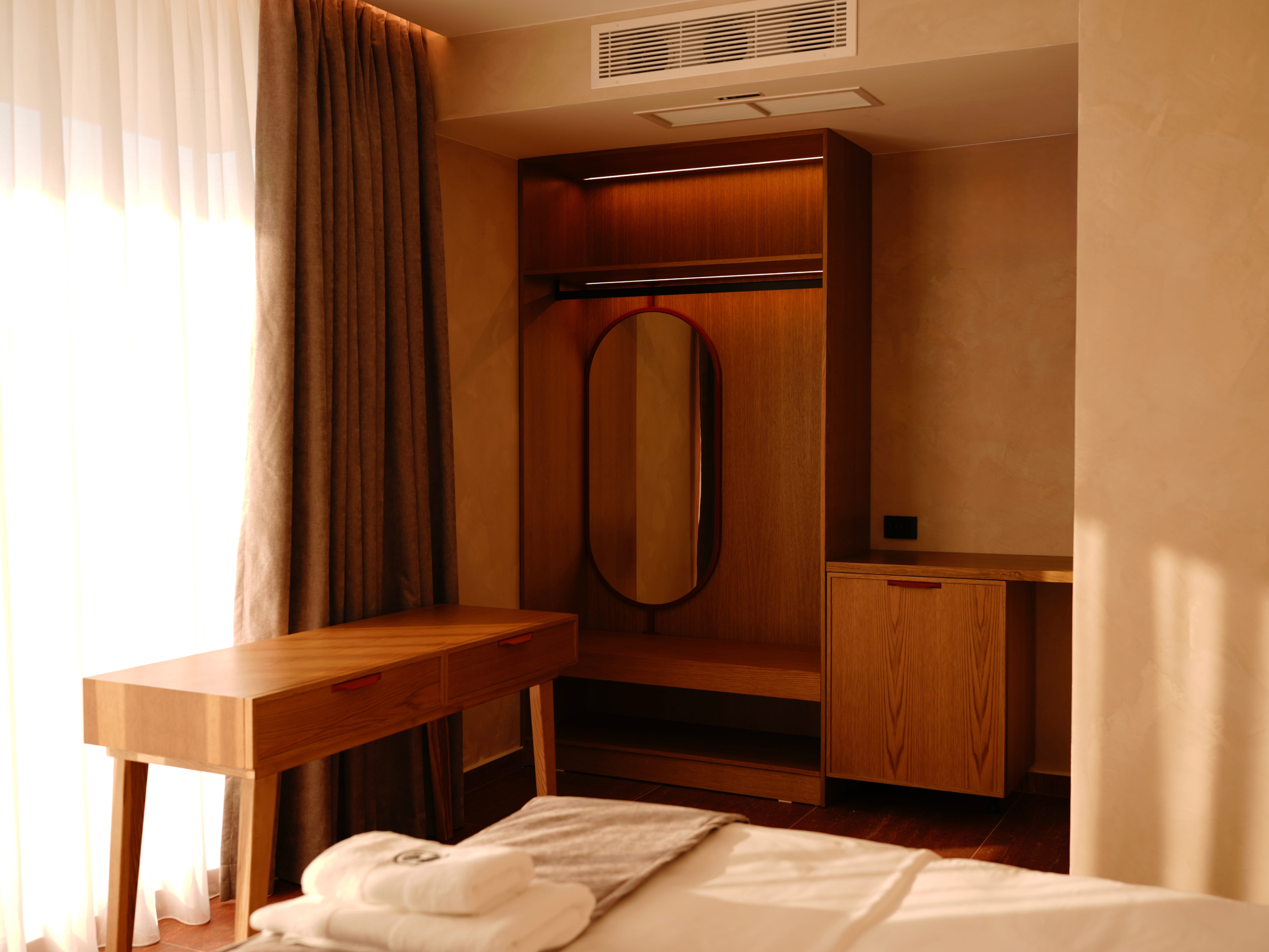 a room with a mirror and a bed