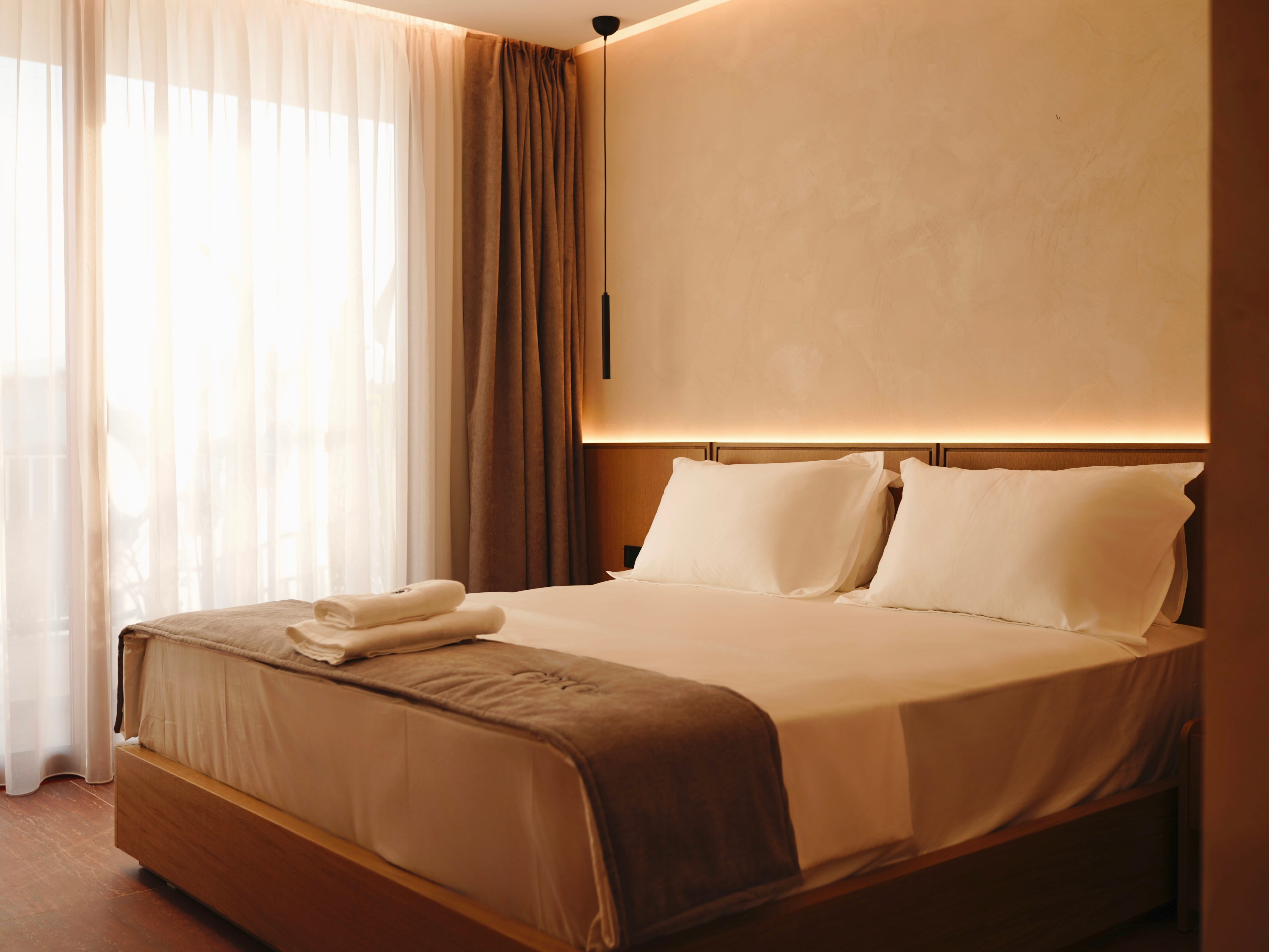 a bed with white sheets and a blanket