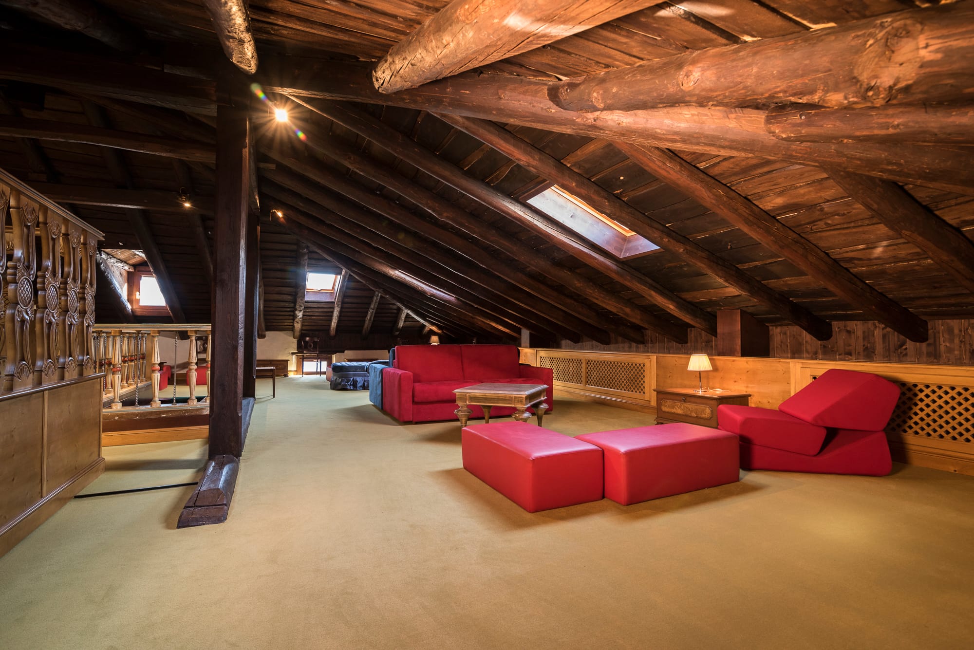 a room with red couches and a tv