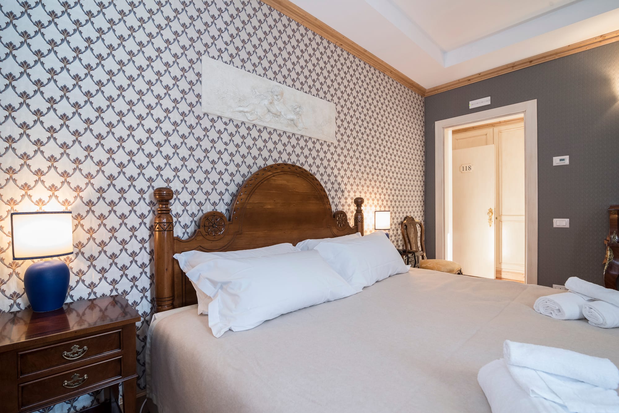 a bedroom with a bed and lamps