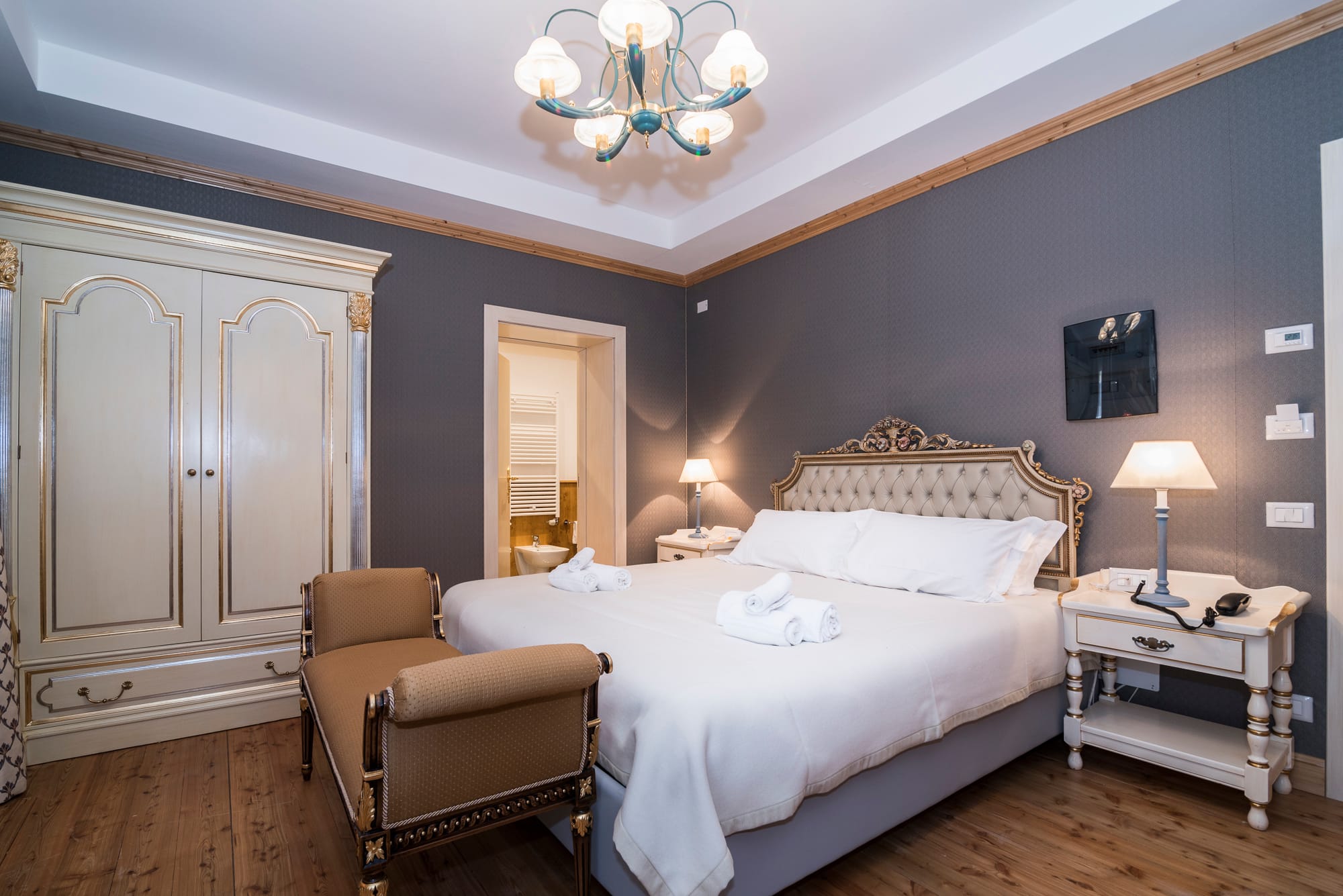 a bedroom with a bed and a chair
