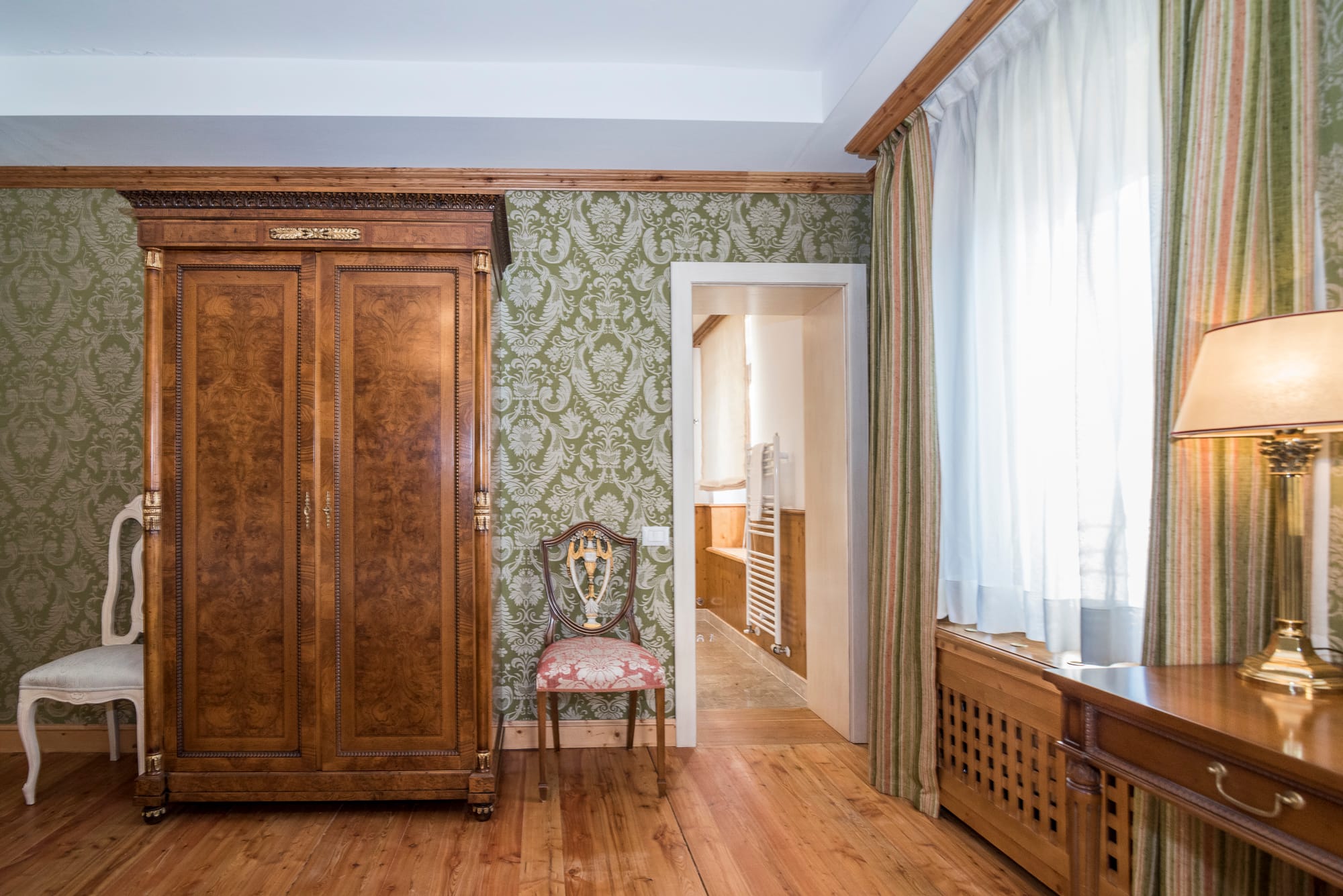 a room with a wood door and a chair