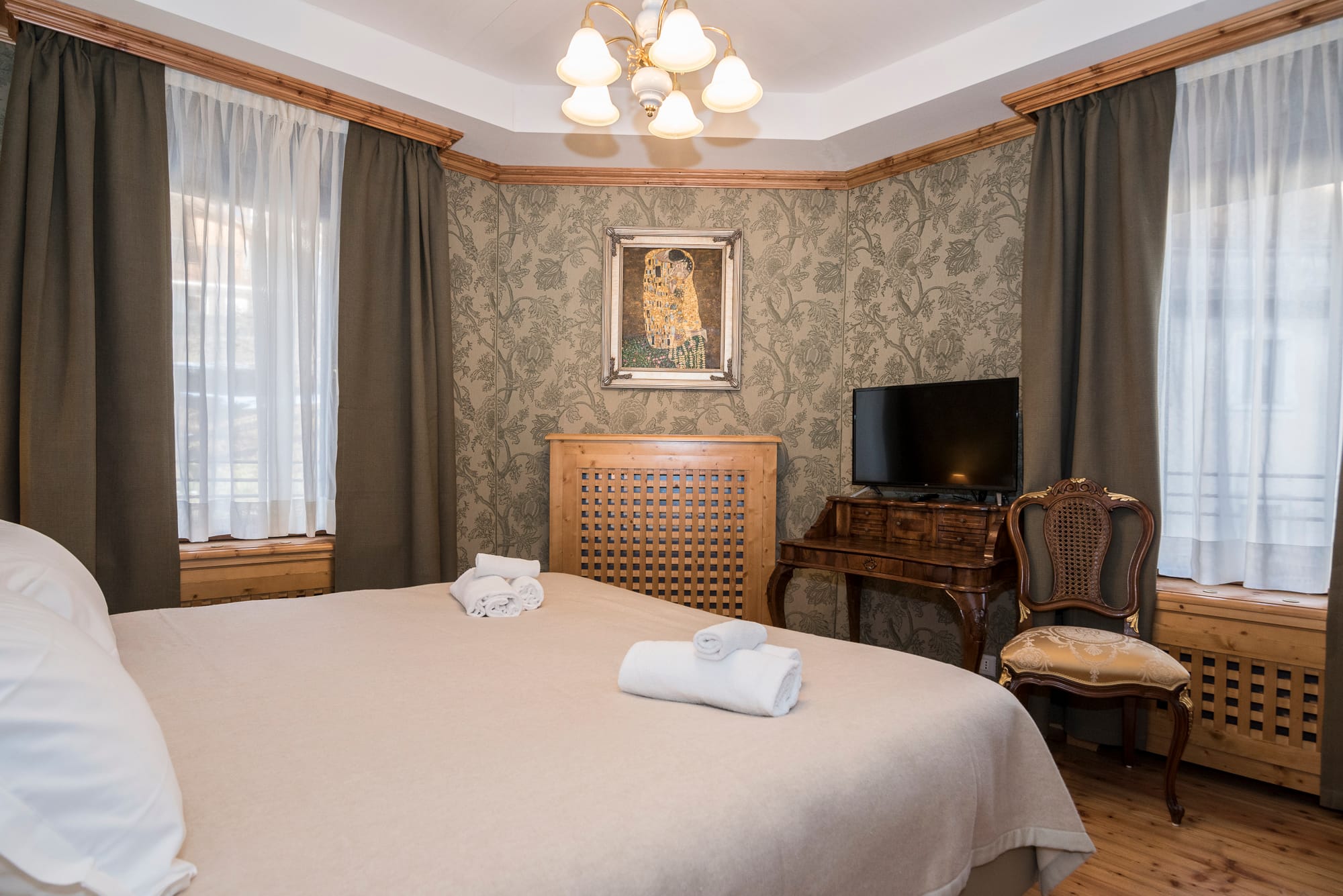 a hotel room with a bed and chairs