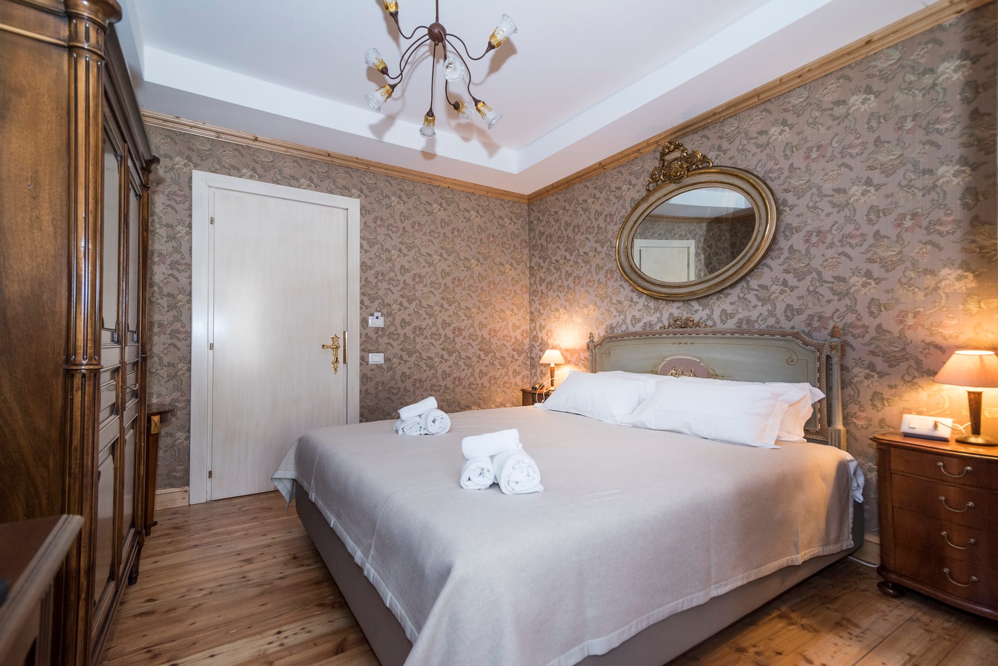 a bed with a mirror above it