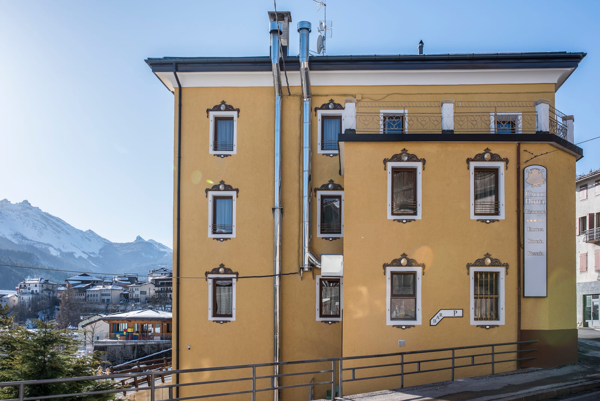 a yellow building with a fence