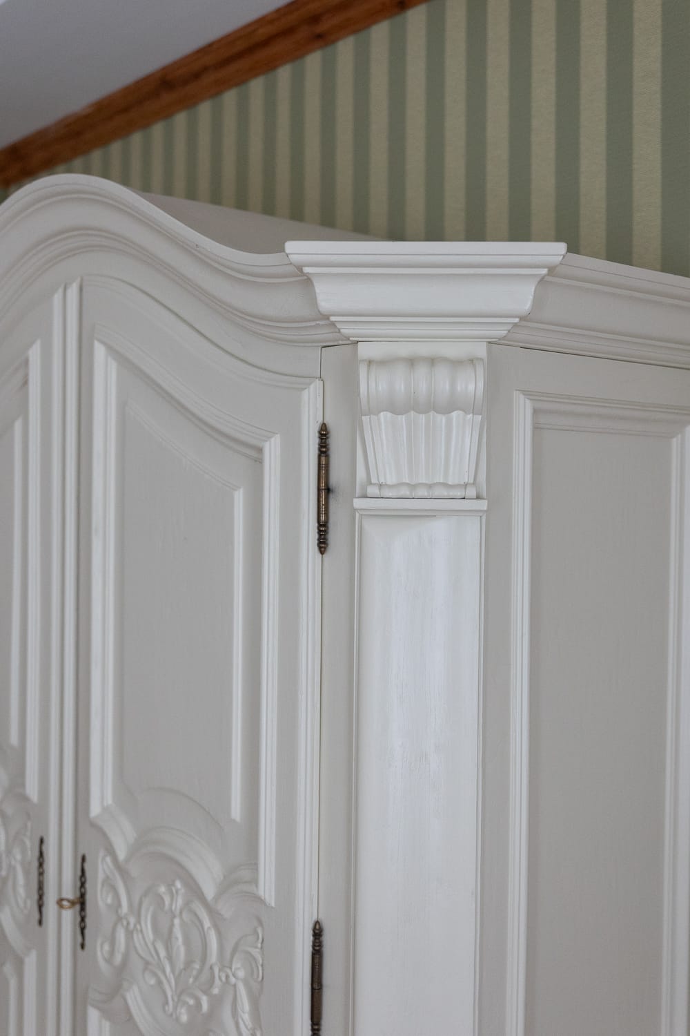 a white cabinet with a decorative column