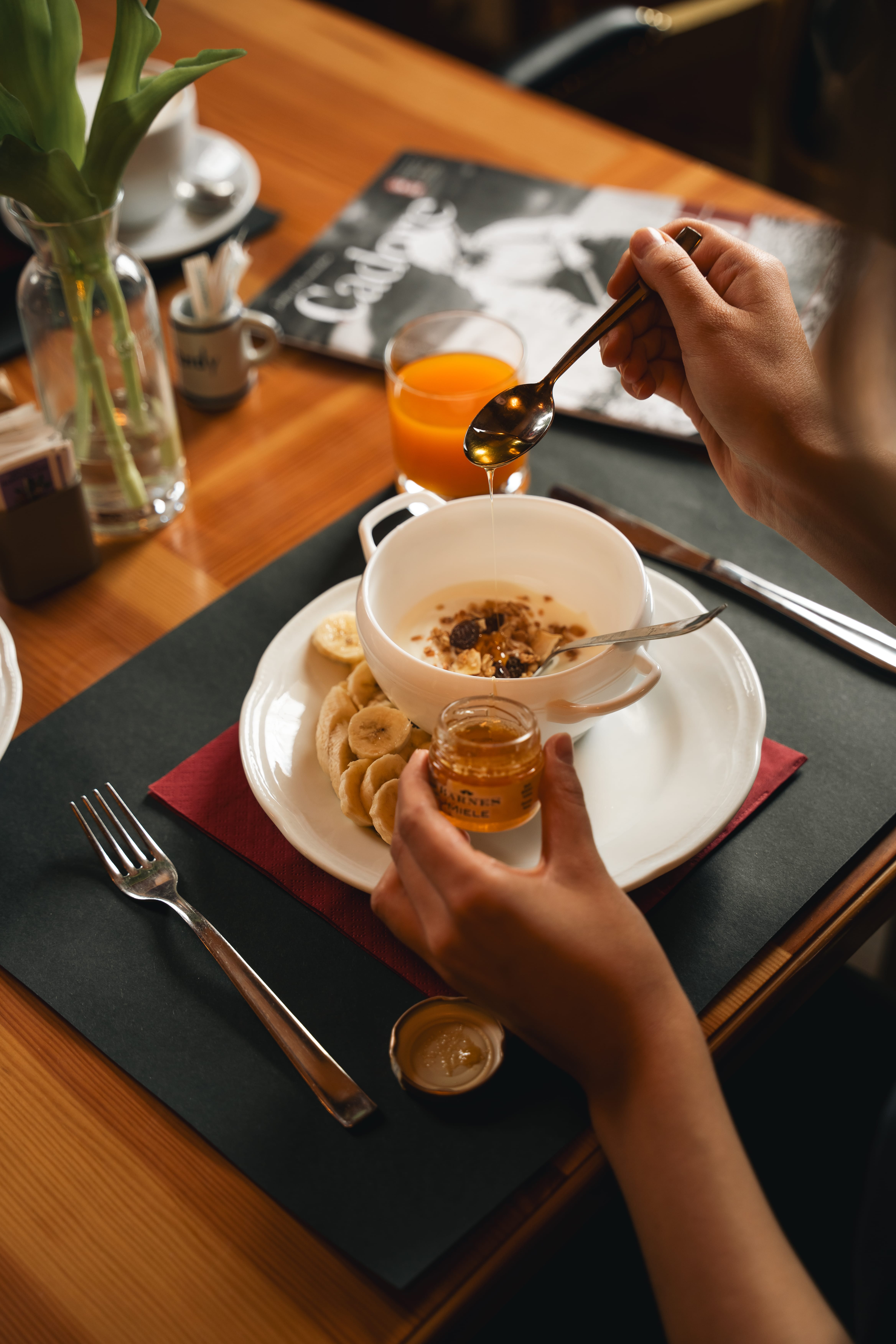 a person pouring a spoon into a bowl of food
