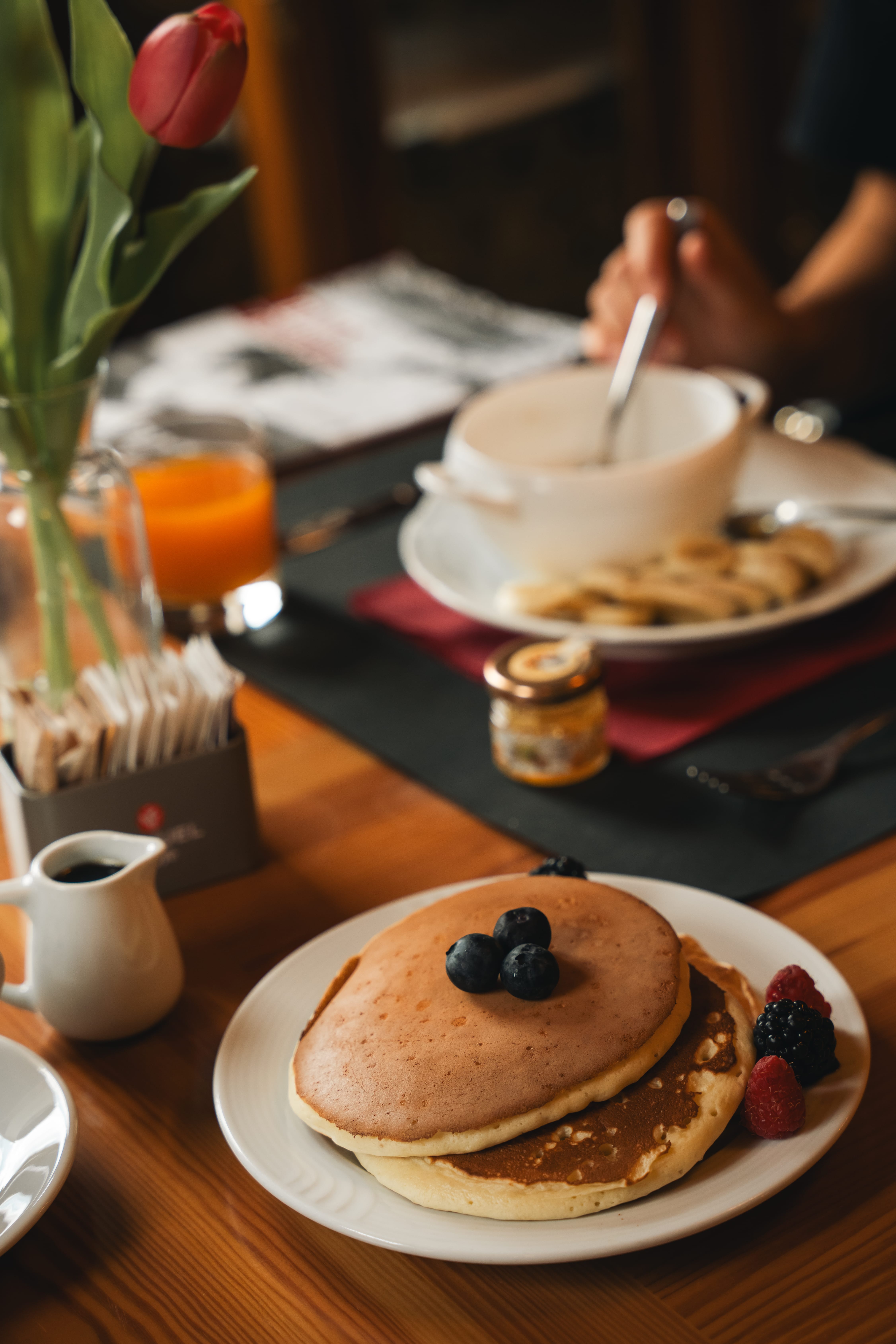 a plate of pancakes with berries on it