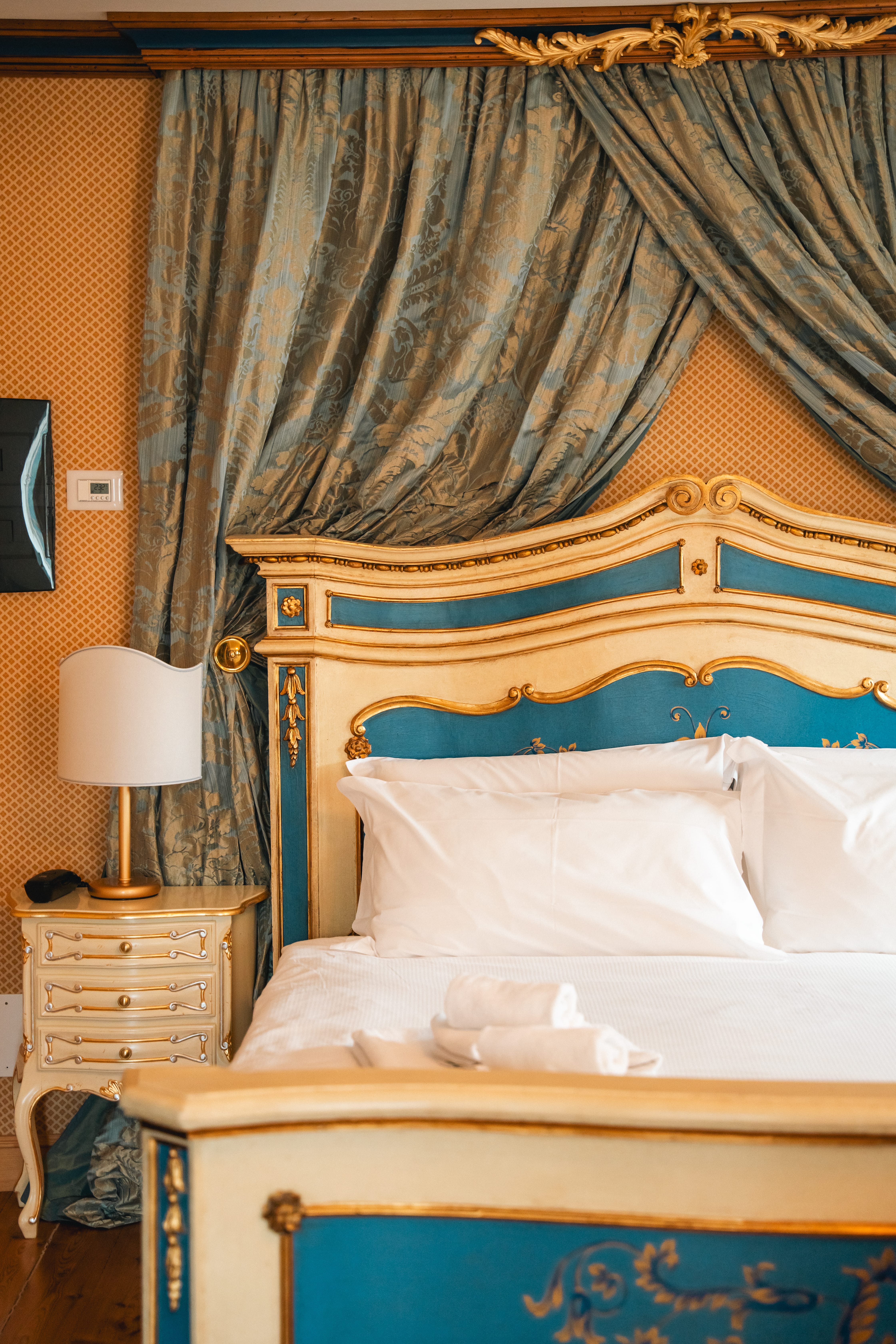 a bed with a lamp and a curtain over it