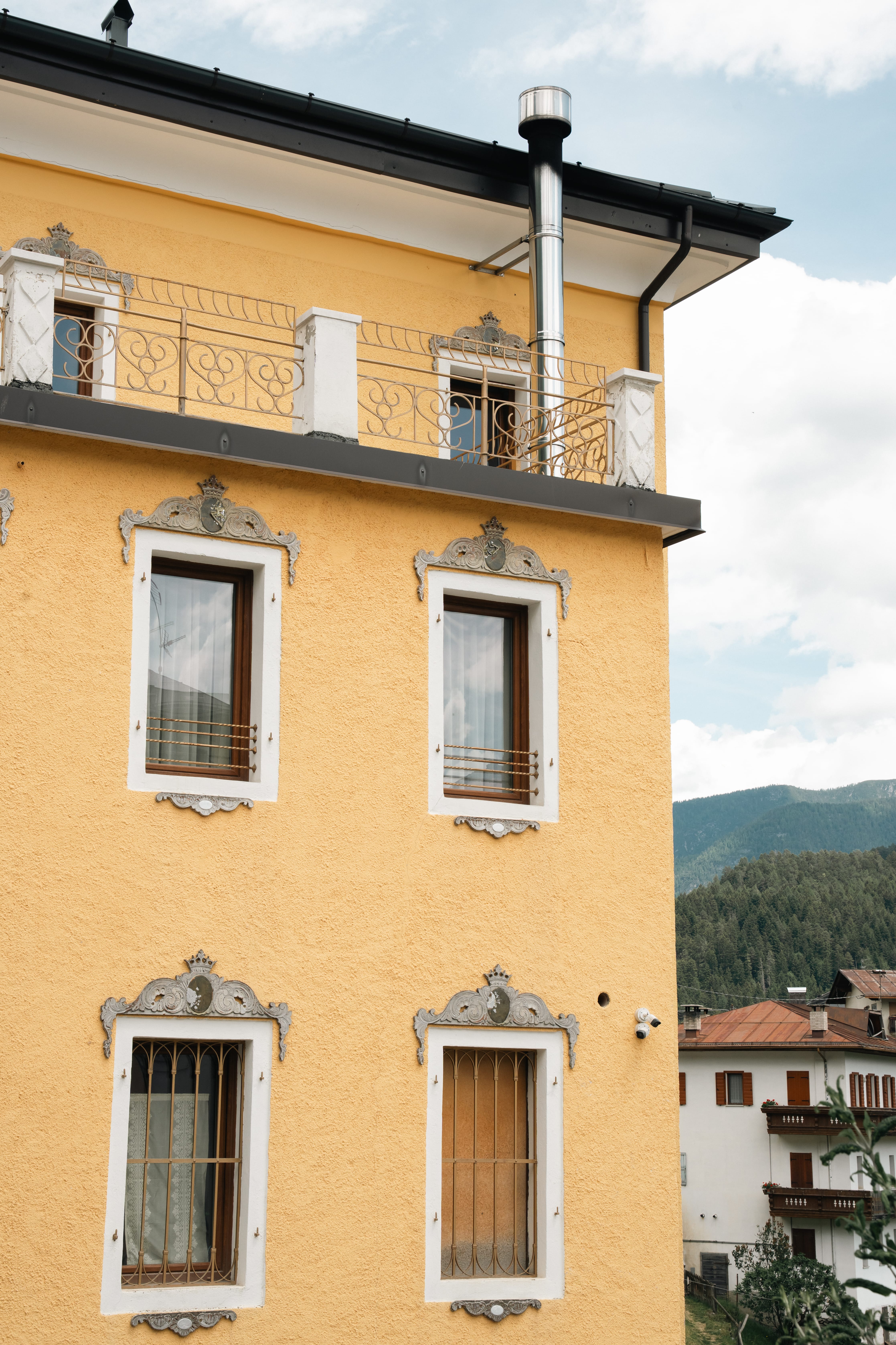 a yellow building with a balcony