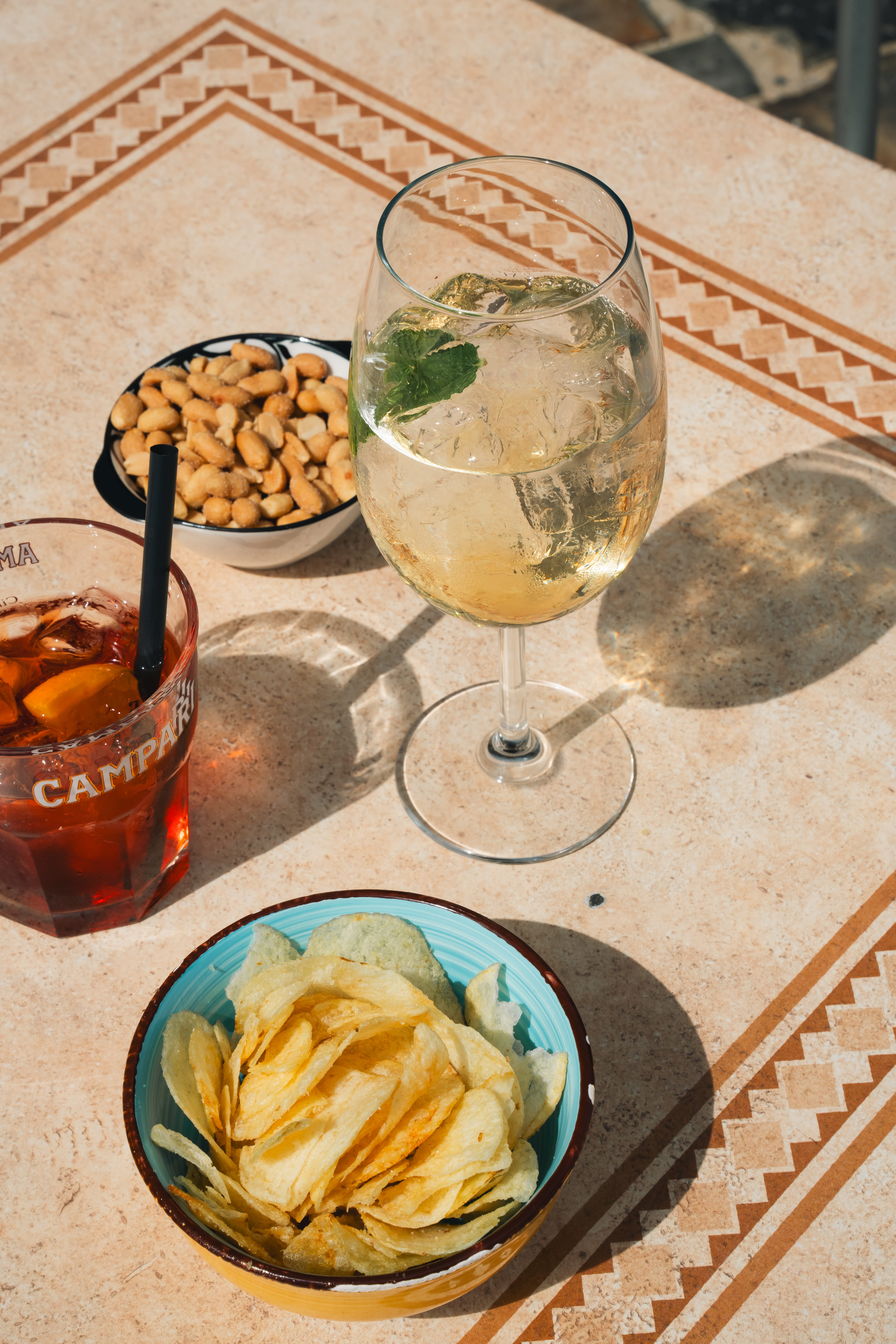 a glass of beer and snacks on a table