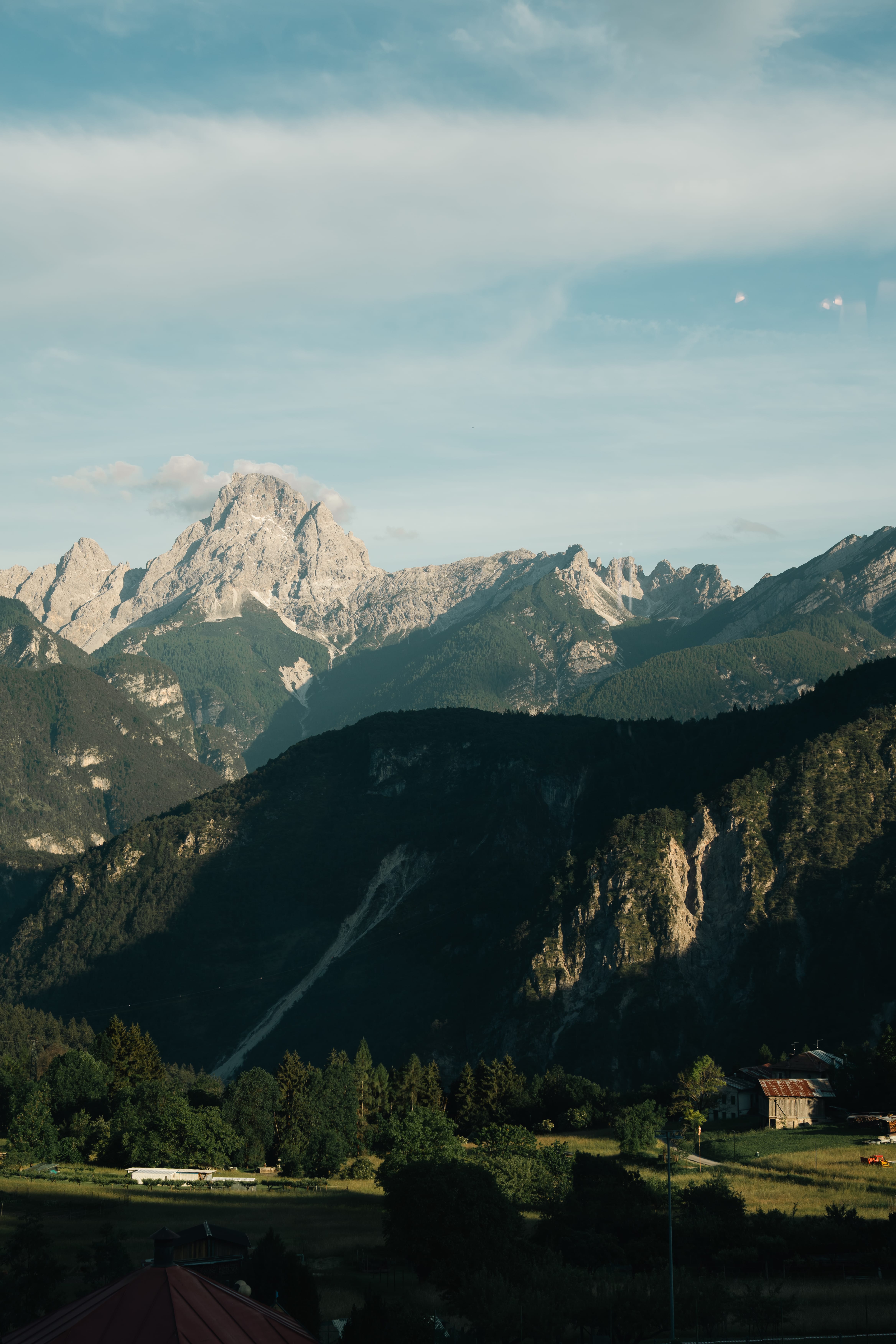 a mountain range with a house in the background