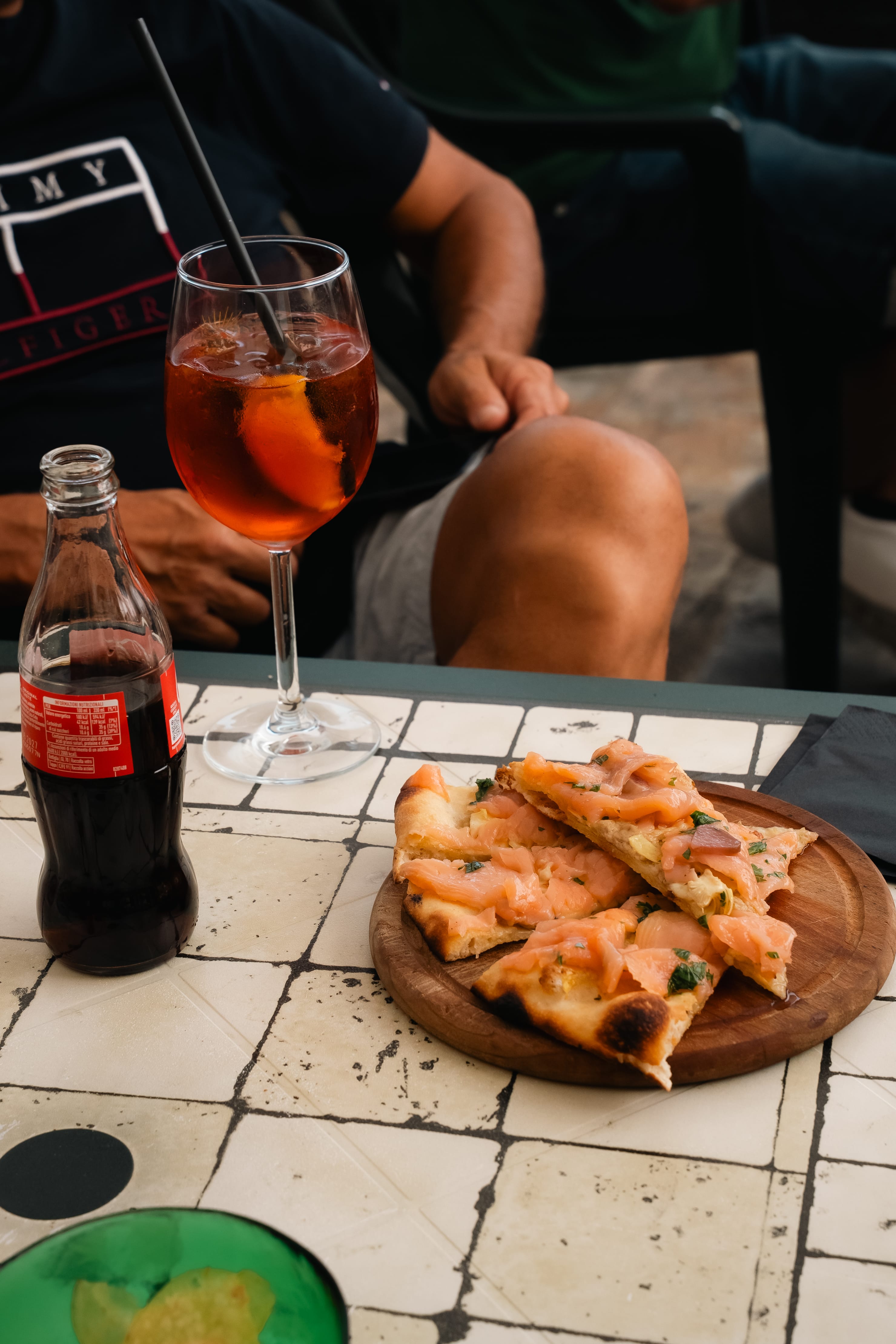 a plate of pizza and a drink on a table