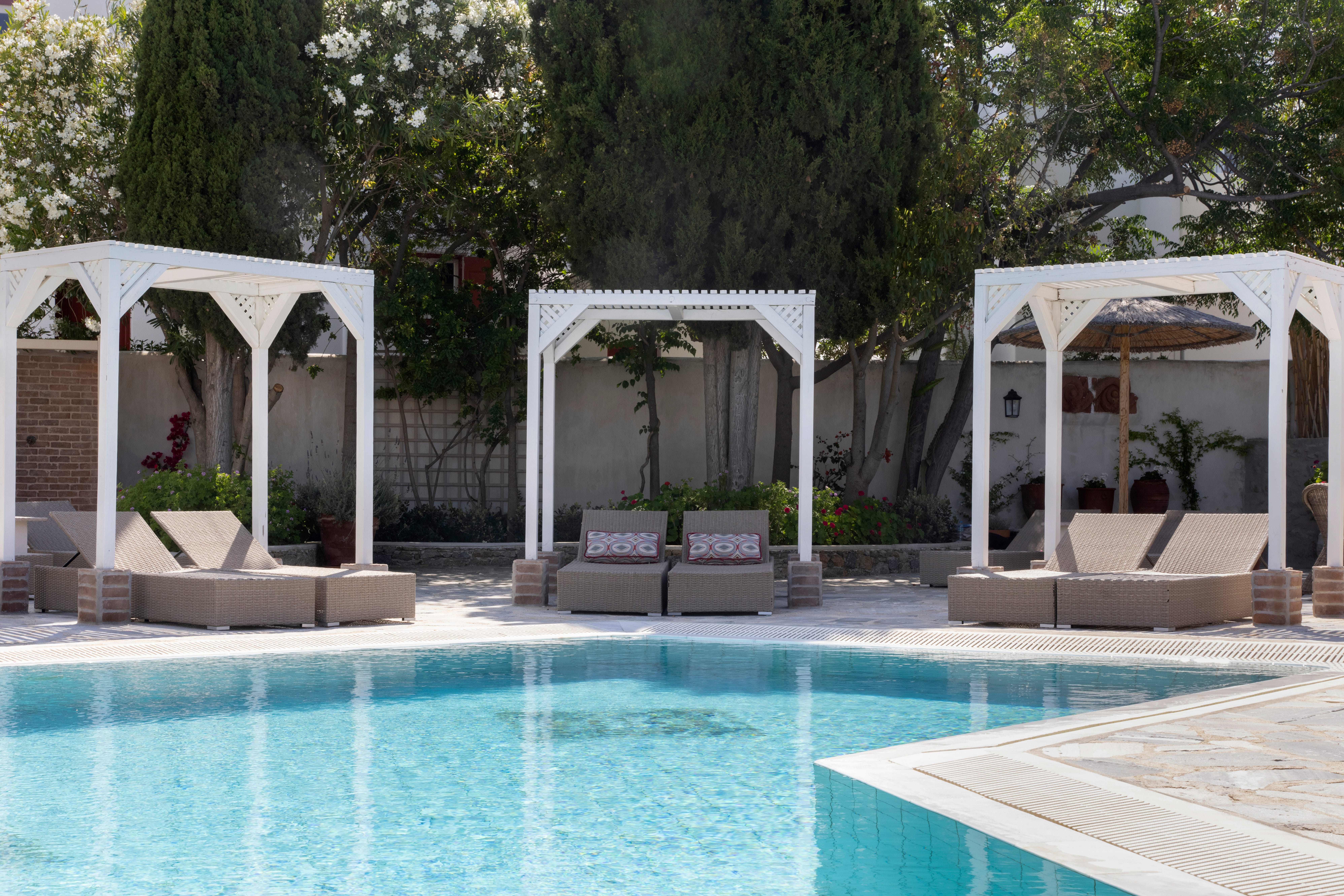 a swimming pool with white gazebo